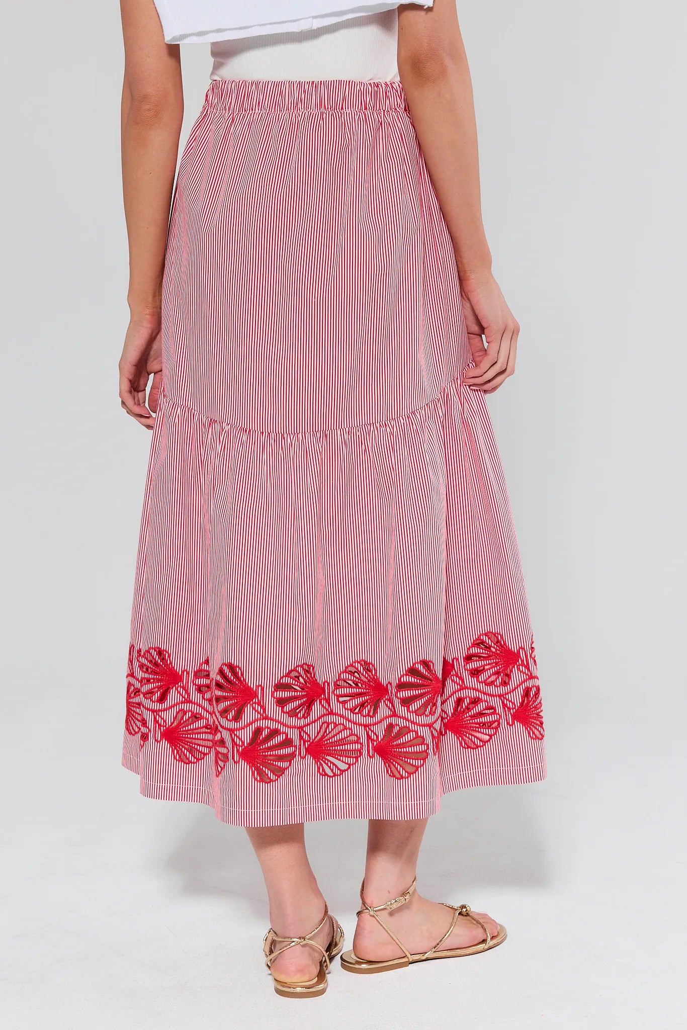 Red and white striped skirt with floral embroidery on a white background