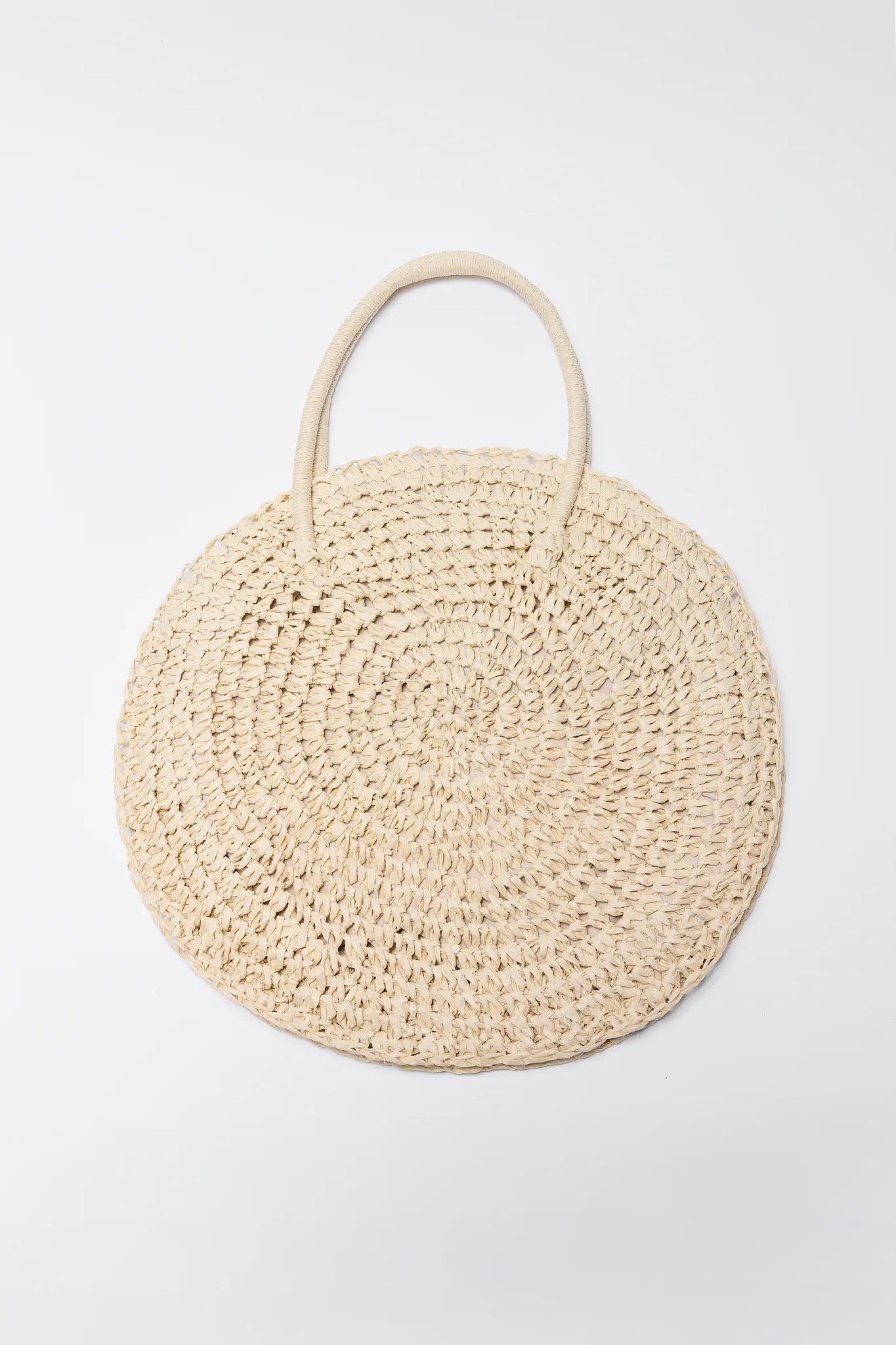 Round Josie Raffia Woven Bucket Bag with handles on a light gray background