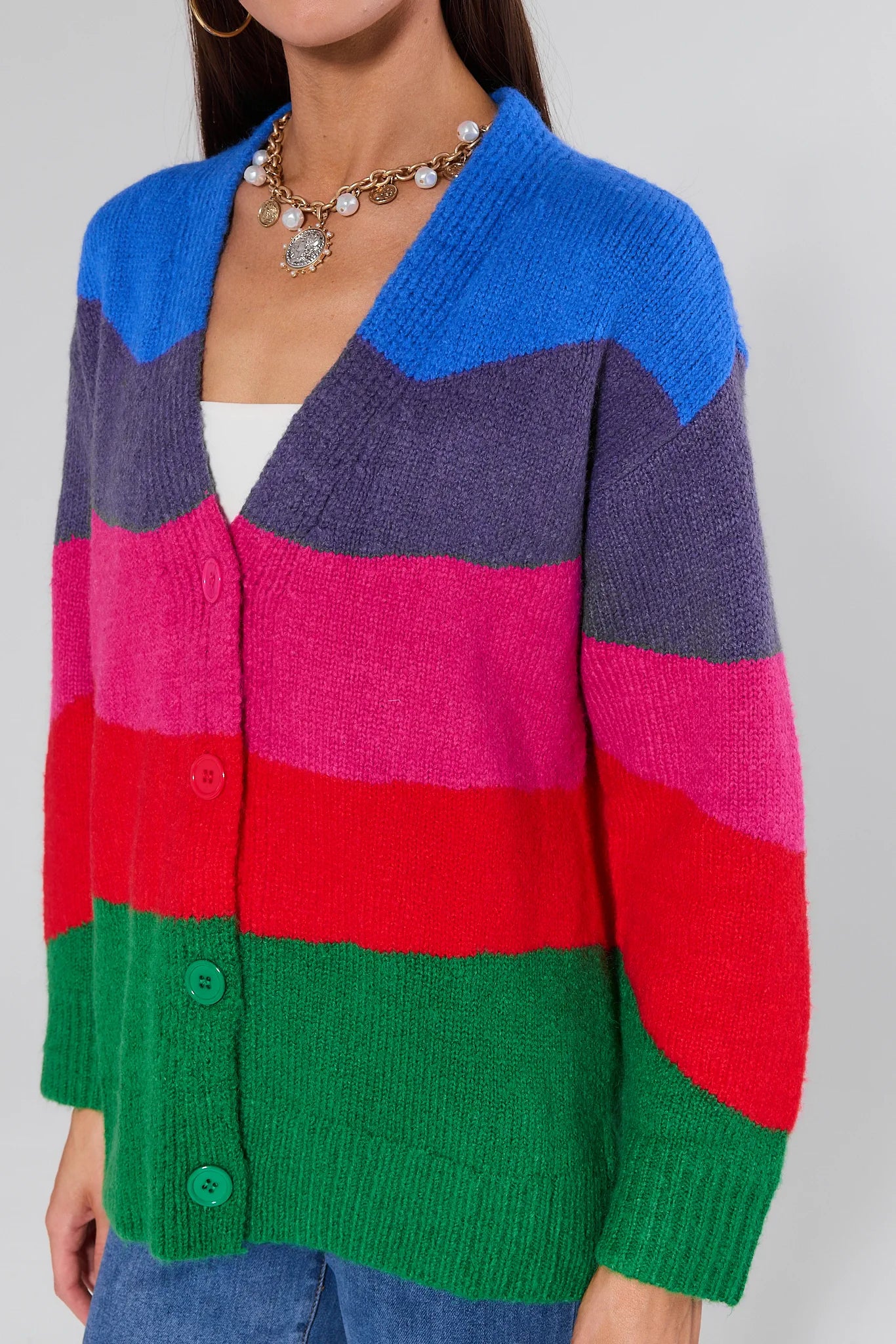 Woman wearing a Brandy Multi Striped Knit Cardigan against a plain background