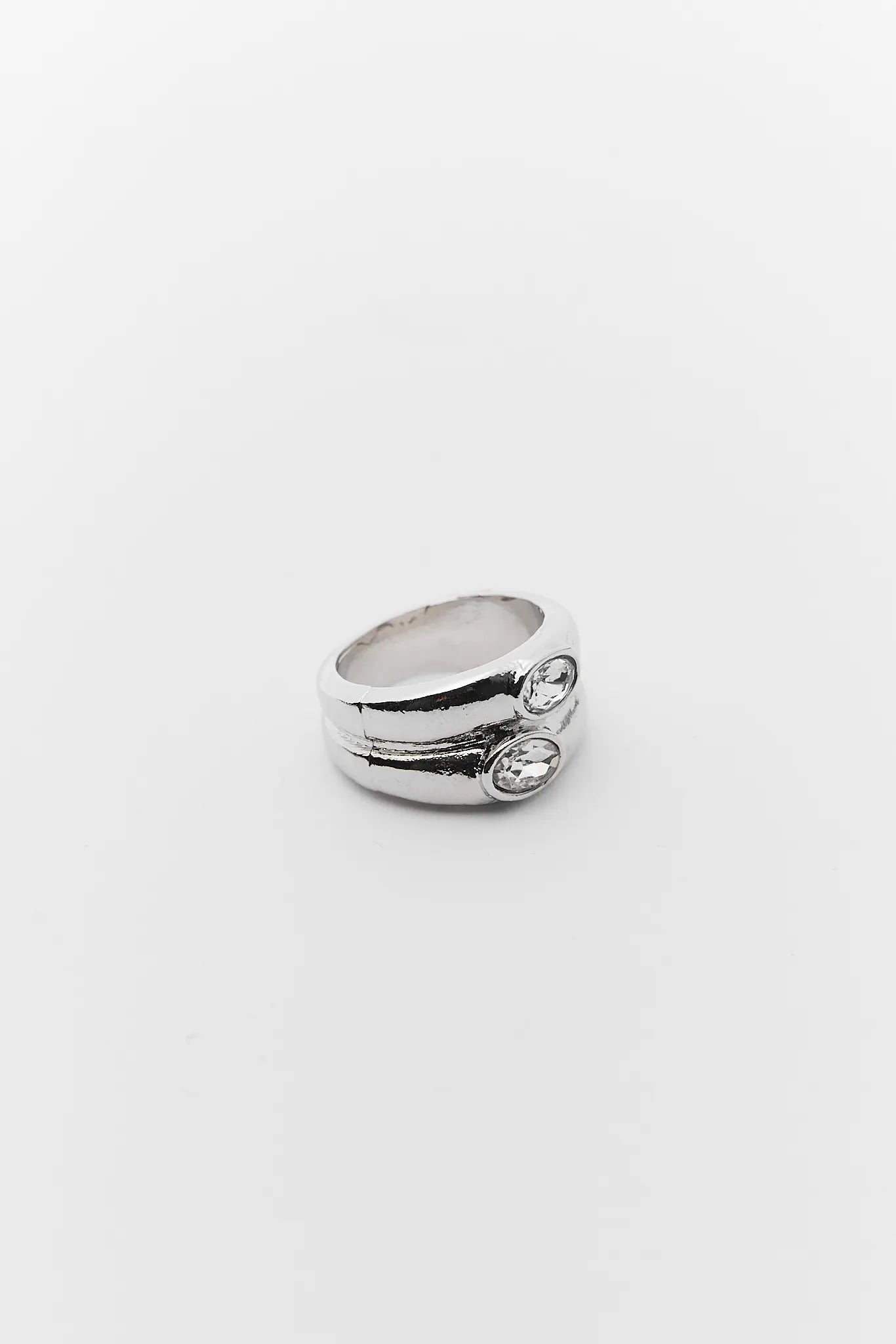 Silver ring with two small stones on a white background
