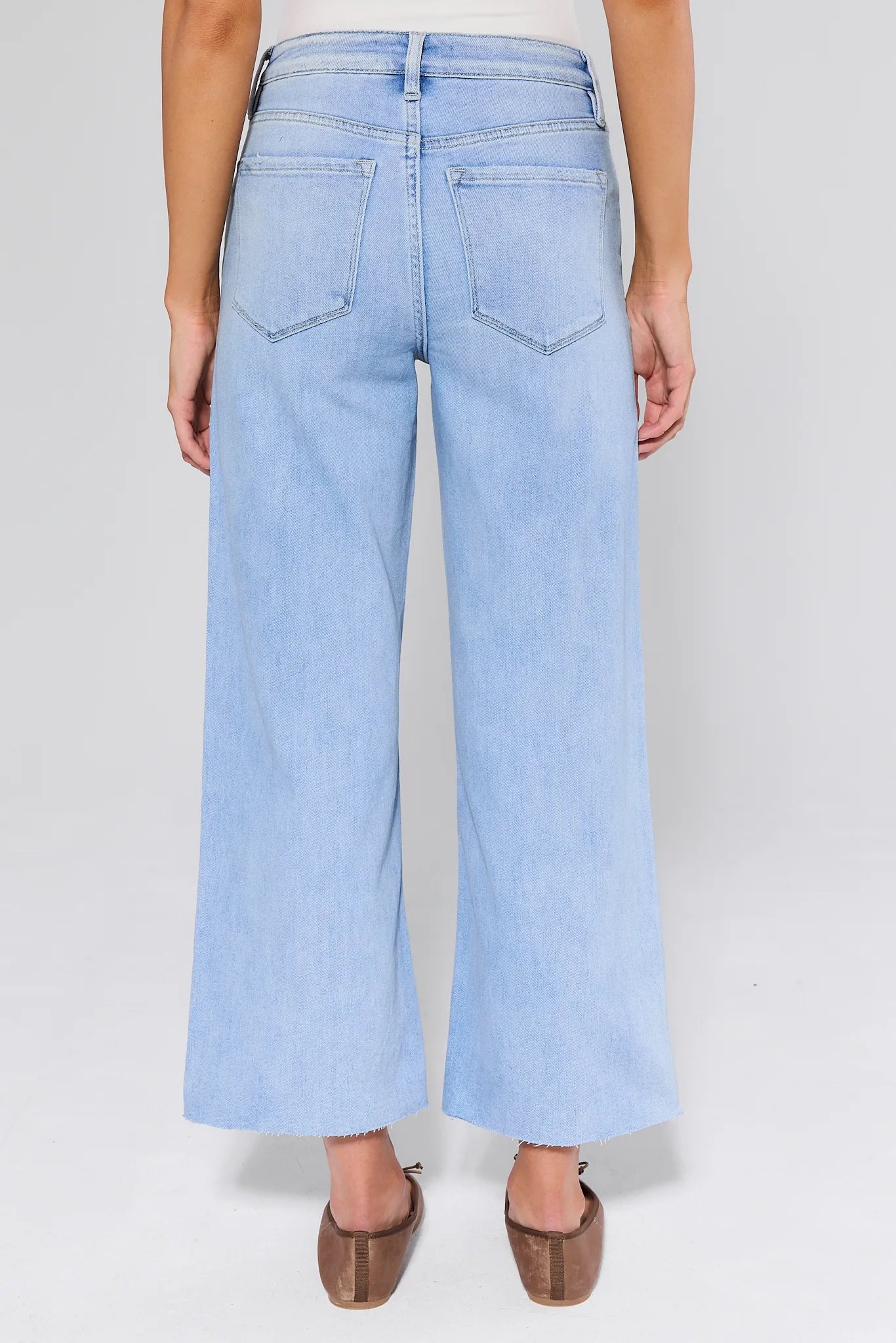 Blake Light Wash Wide Leg Jeans worn by a person on a white background