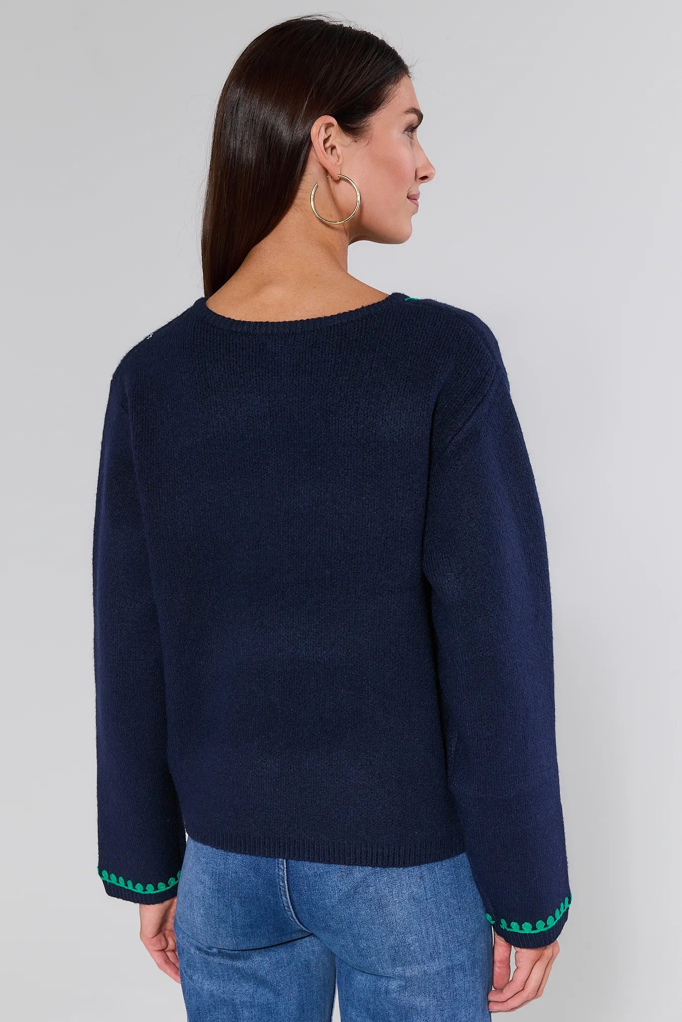 Navy cardigan with green floral patterns Myra Navy Embroidered Cardigan
worn by a person against a neutral background