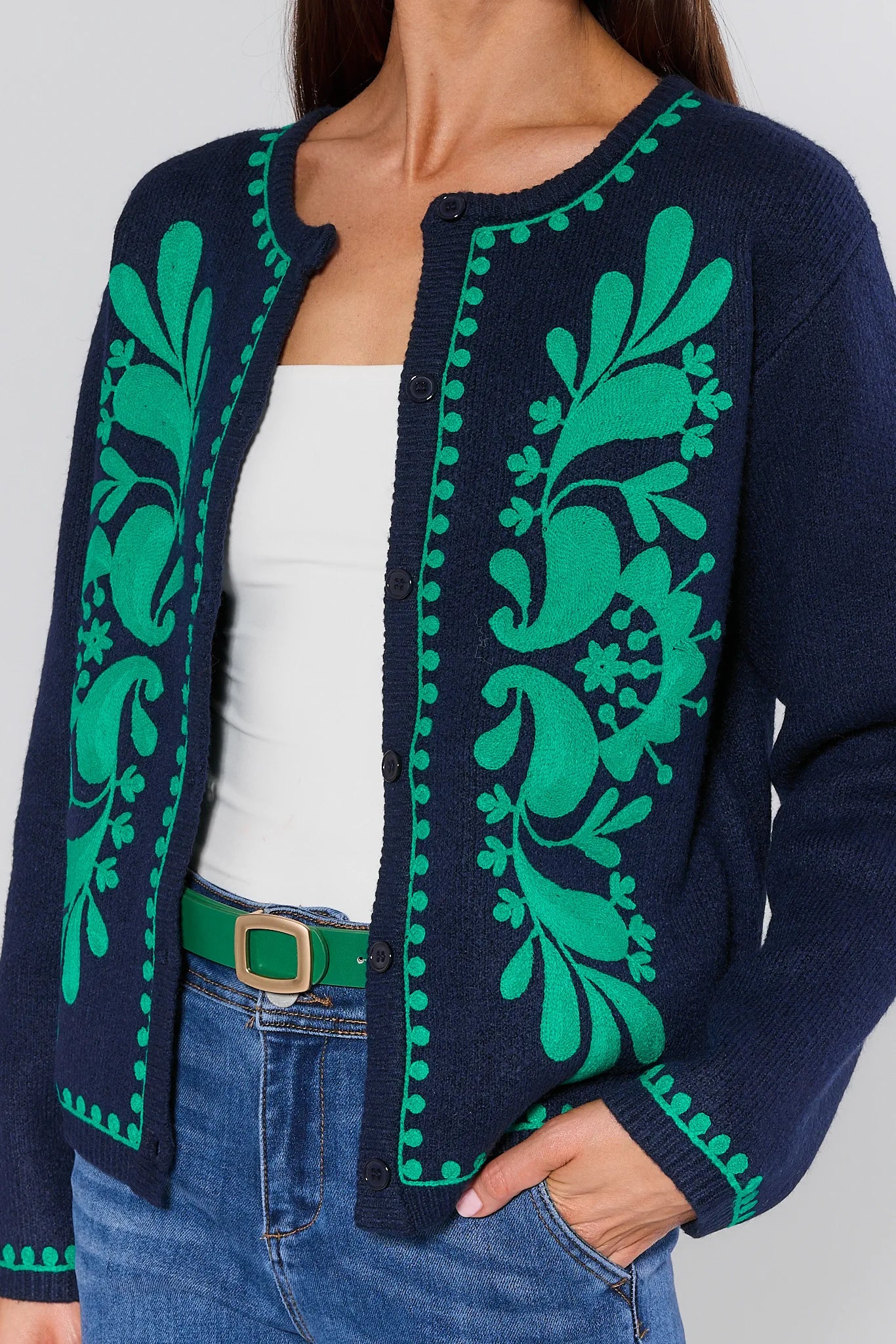 Navy cardigan with green floral patterns Myra Navy Embroidered Cardigan
worn by a person against a neutral background
