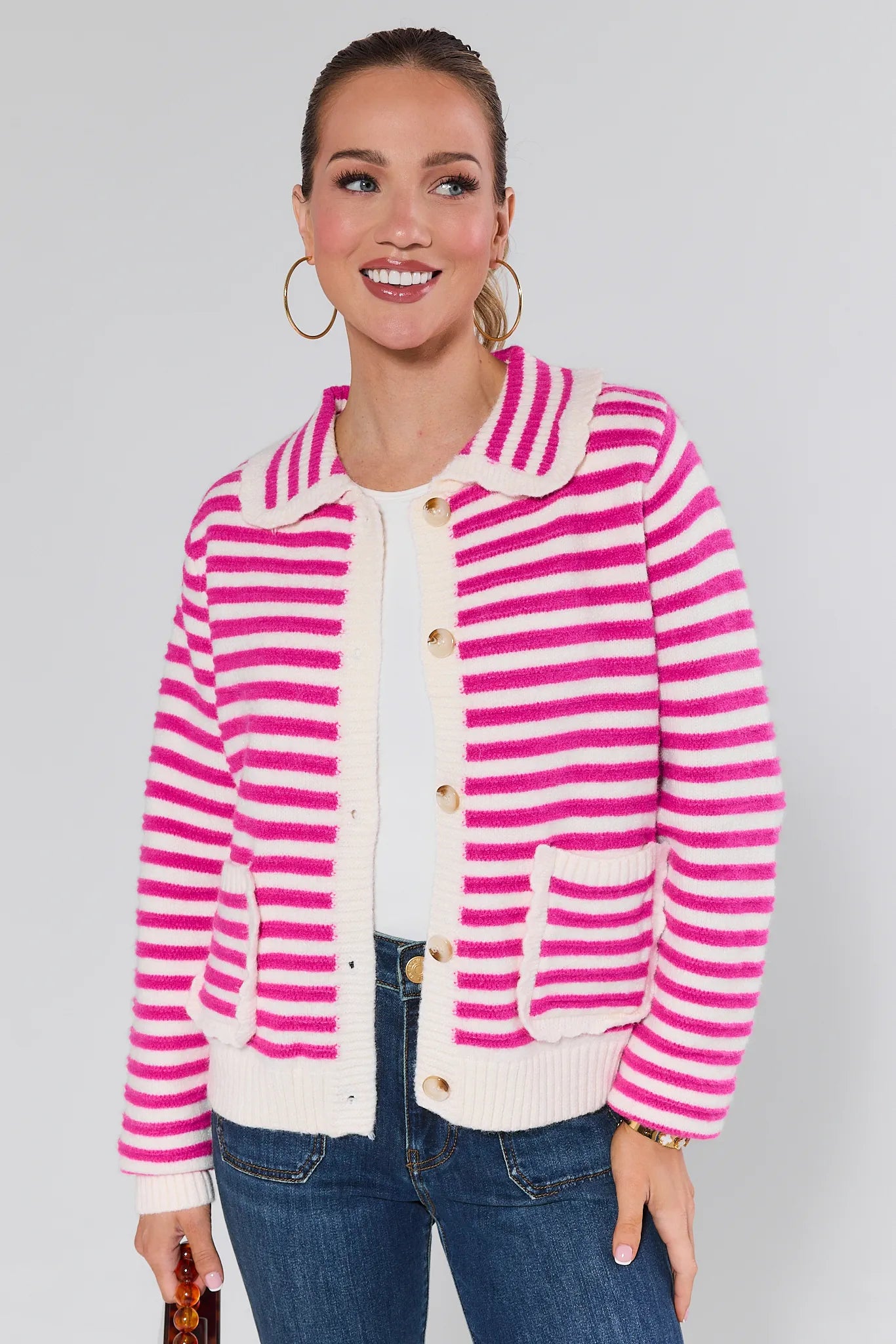 Woman wearing a Arlo Pink Striped Knit Cardigan against a plain background