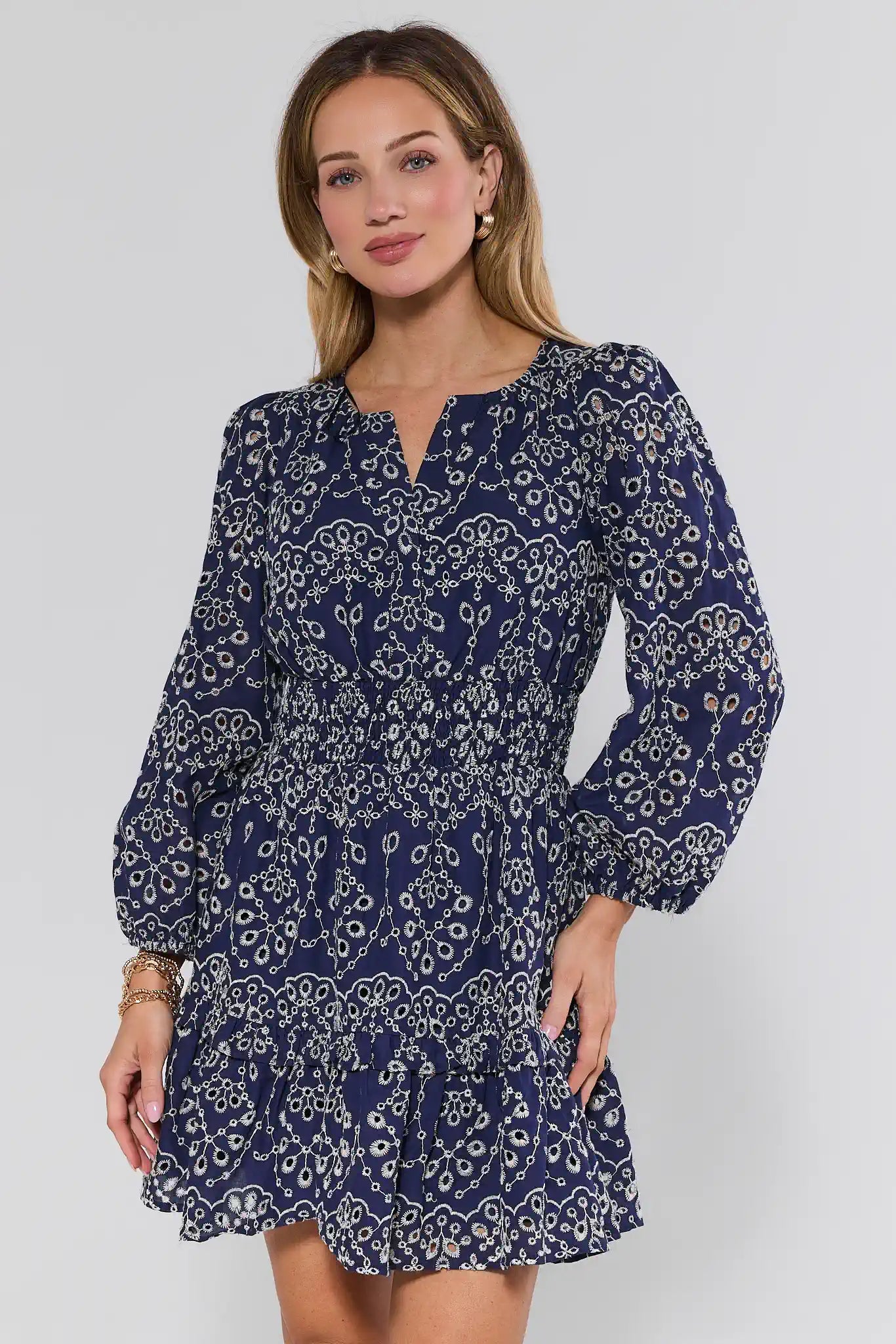 Woman wearing a blue patterned dress on a white background