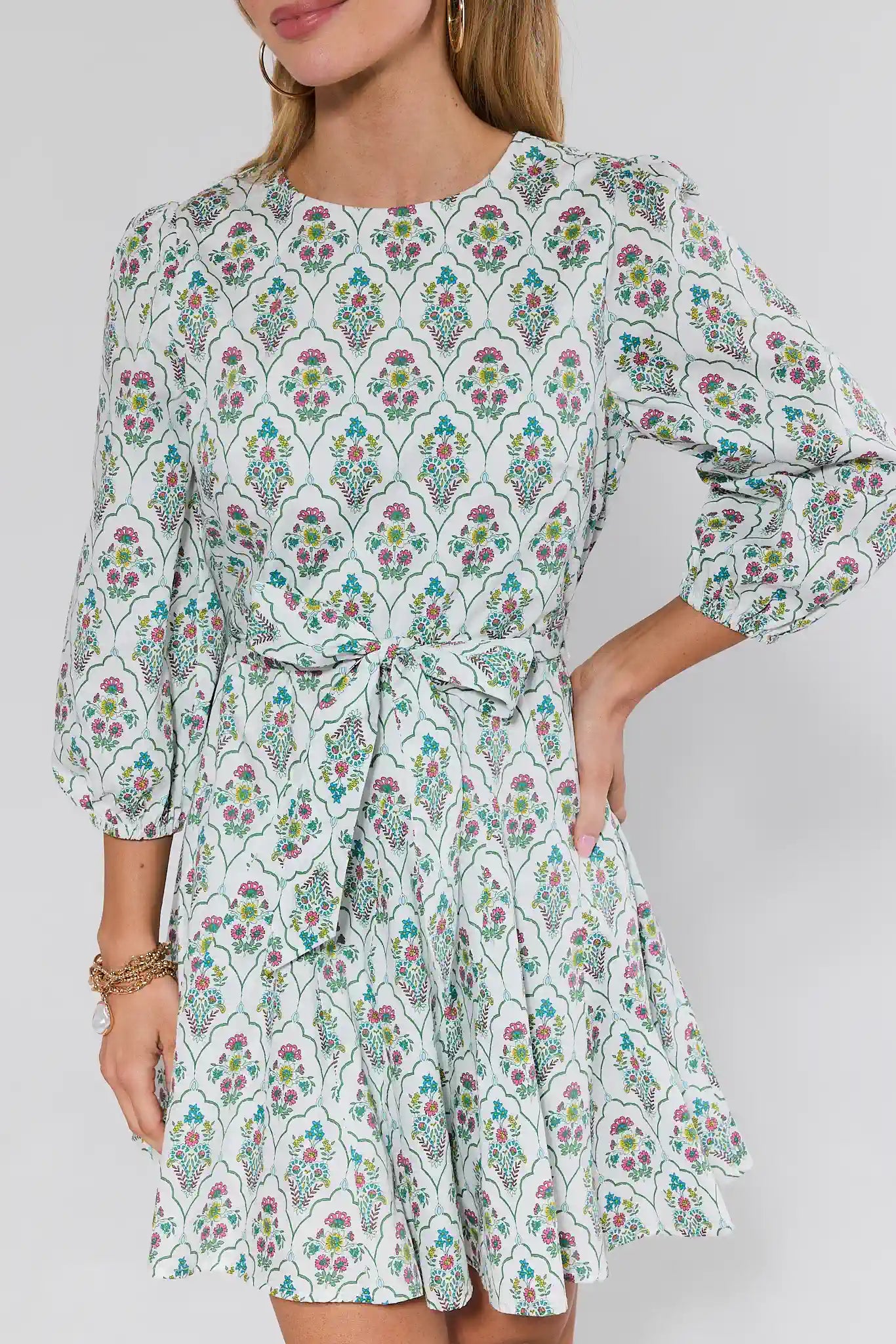 Woman wearing a floral dress with a plain background