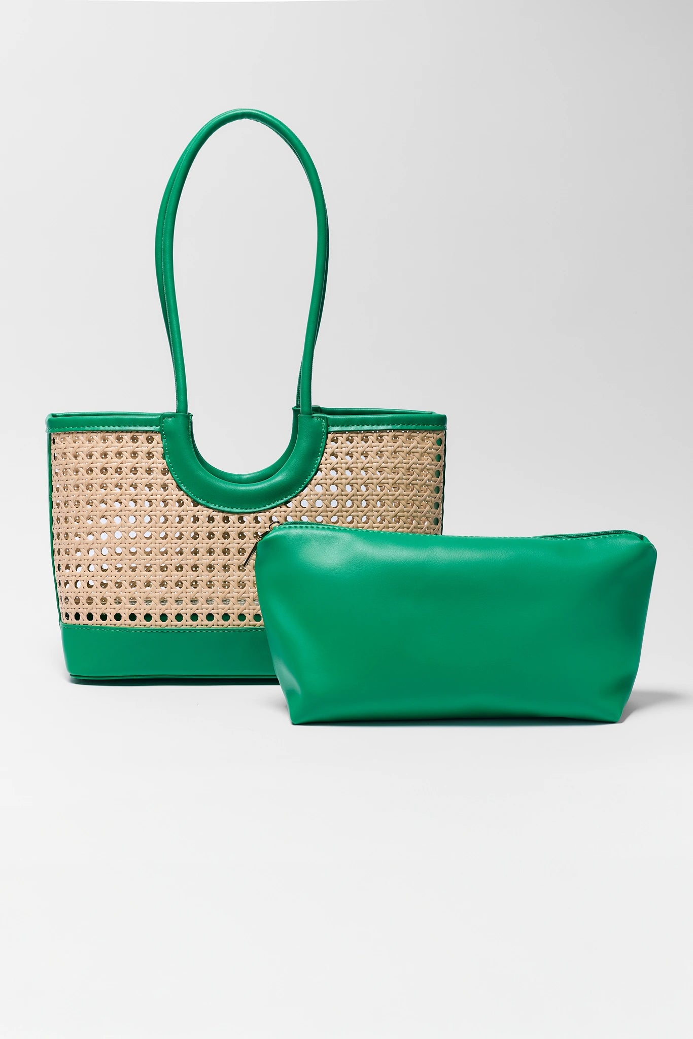 Green handbag with woven design and matching pouch on a white background