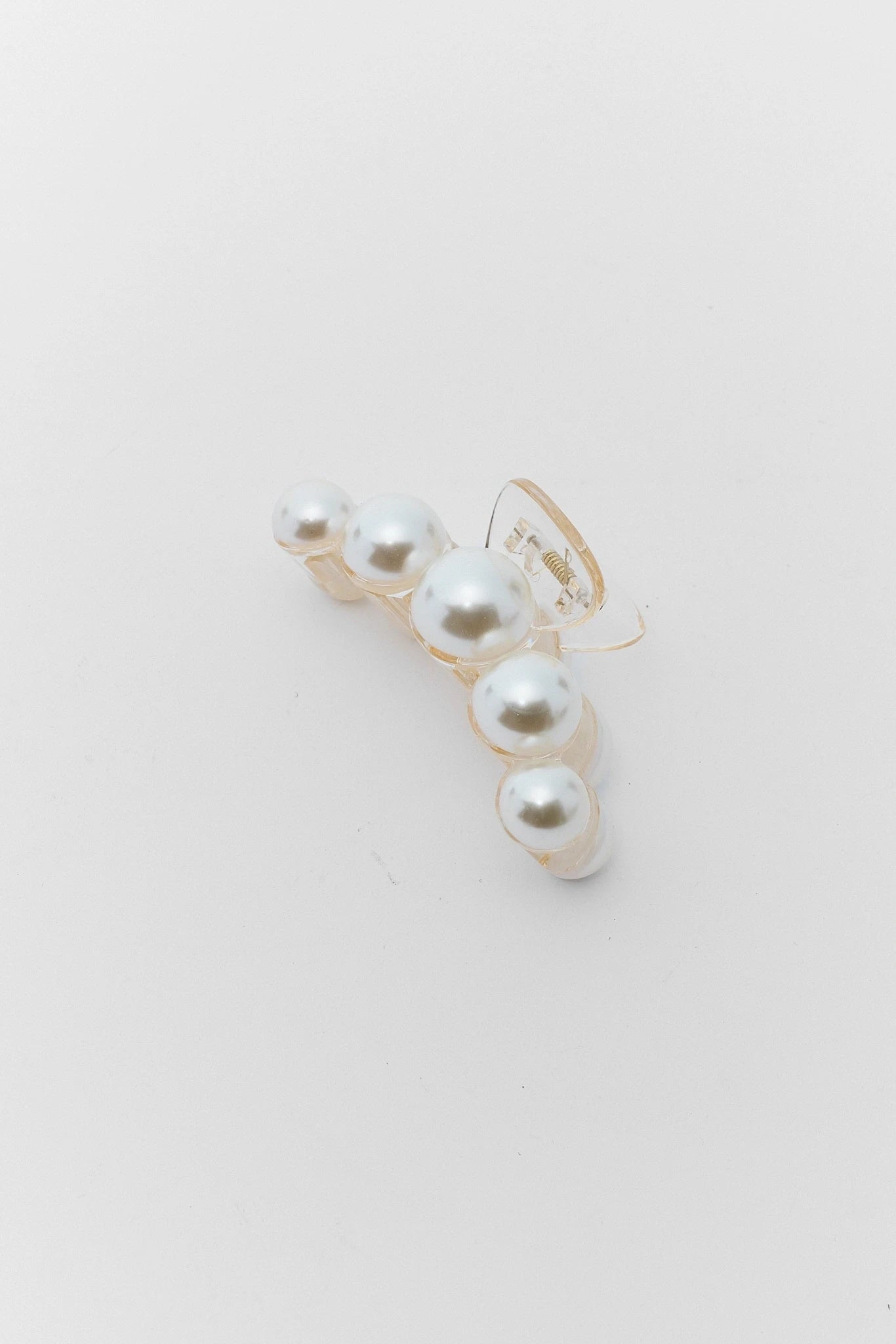 Pearl earring on a light gray background