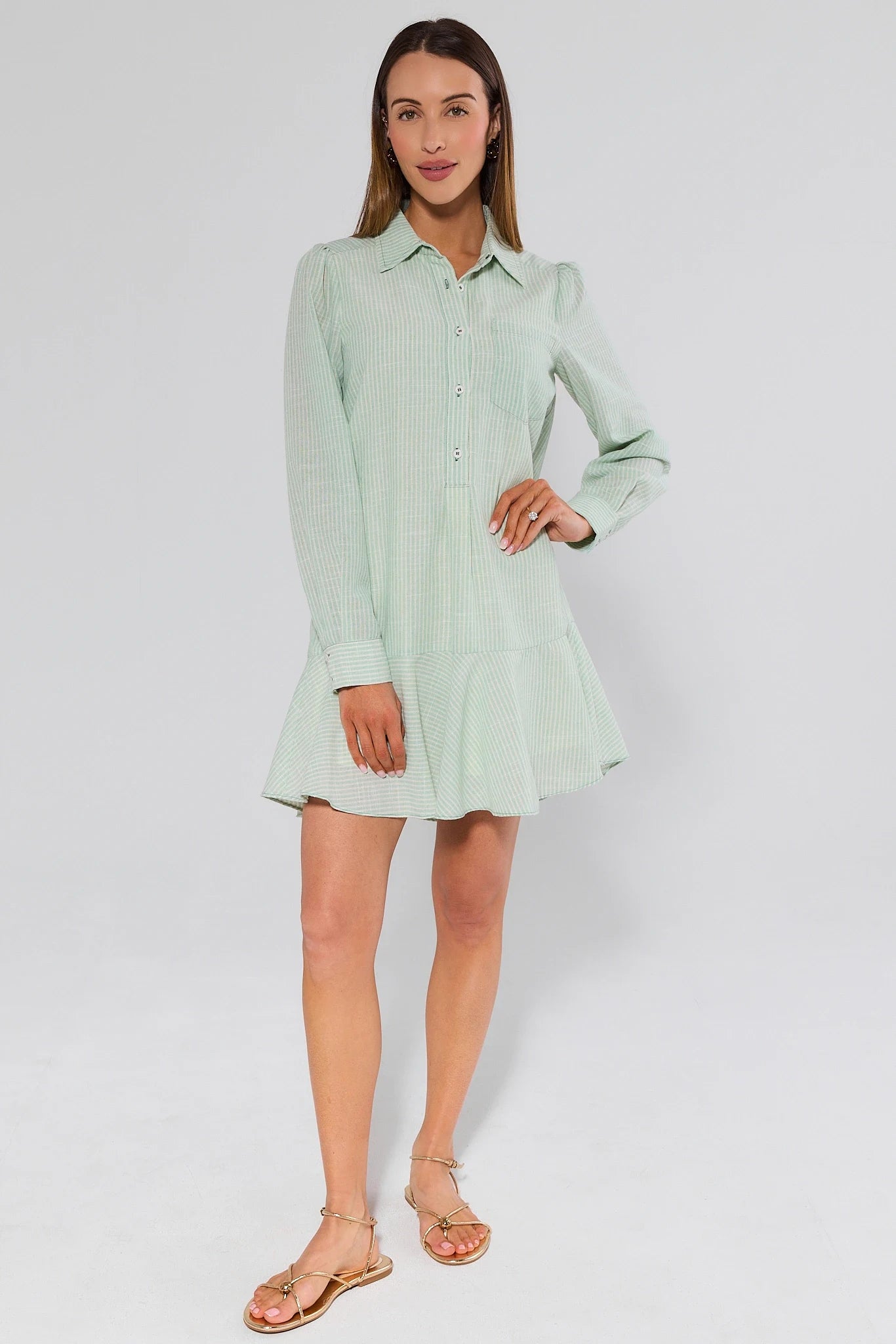 Woman wearing a light green dress on a white background