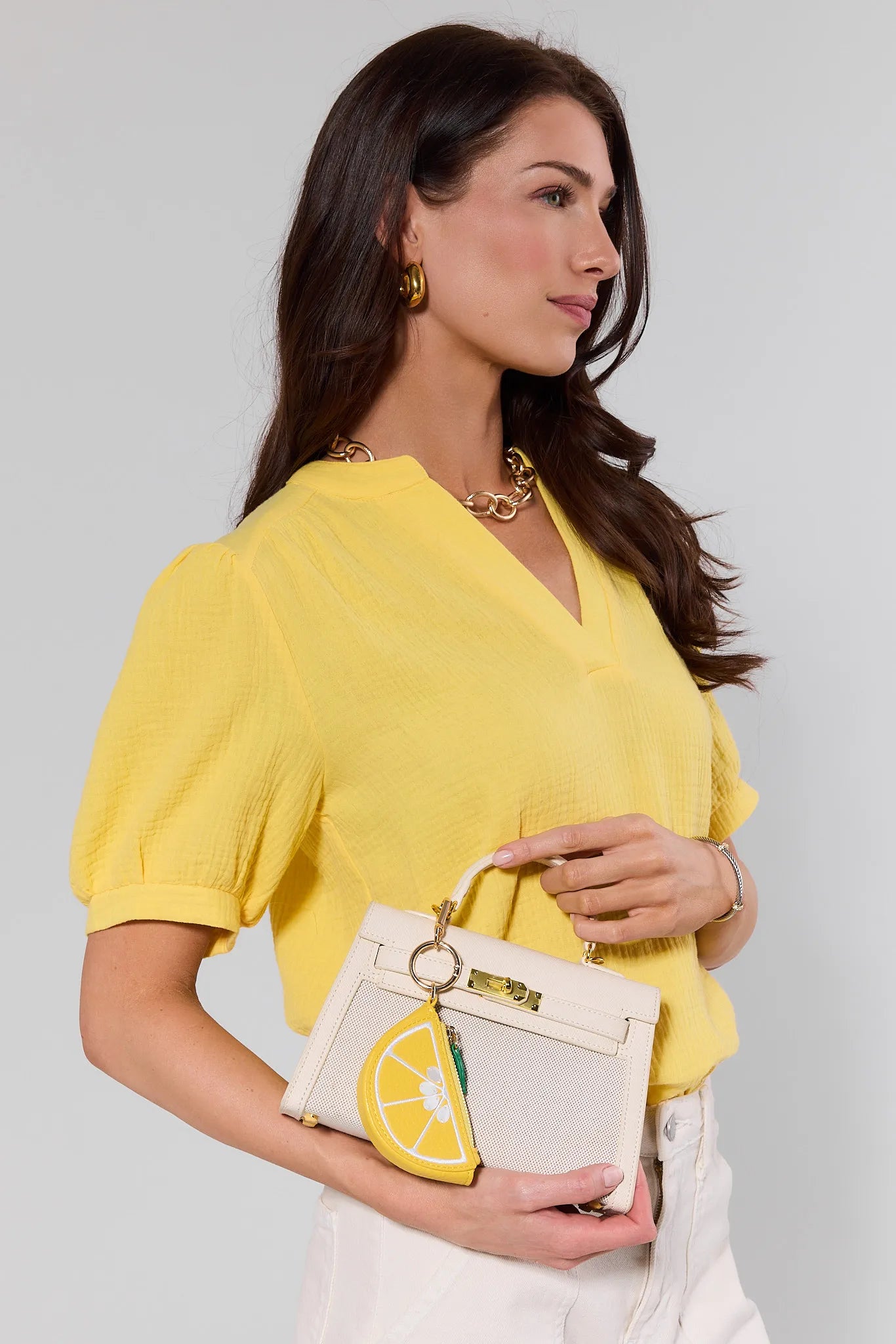 yellow bag charm on white bag