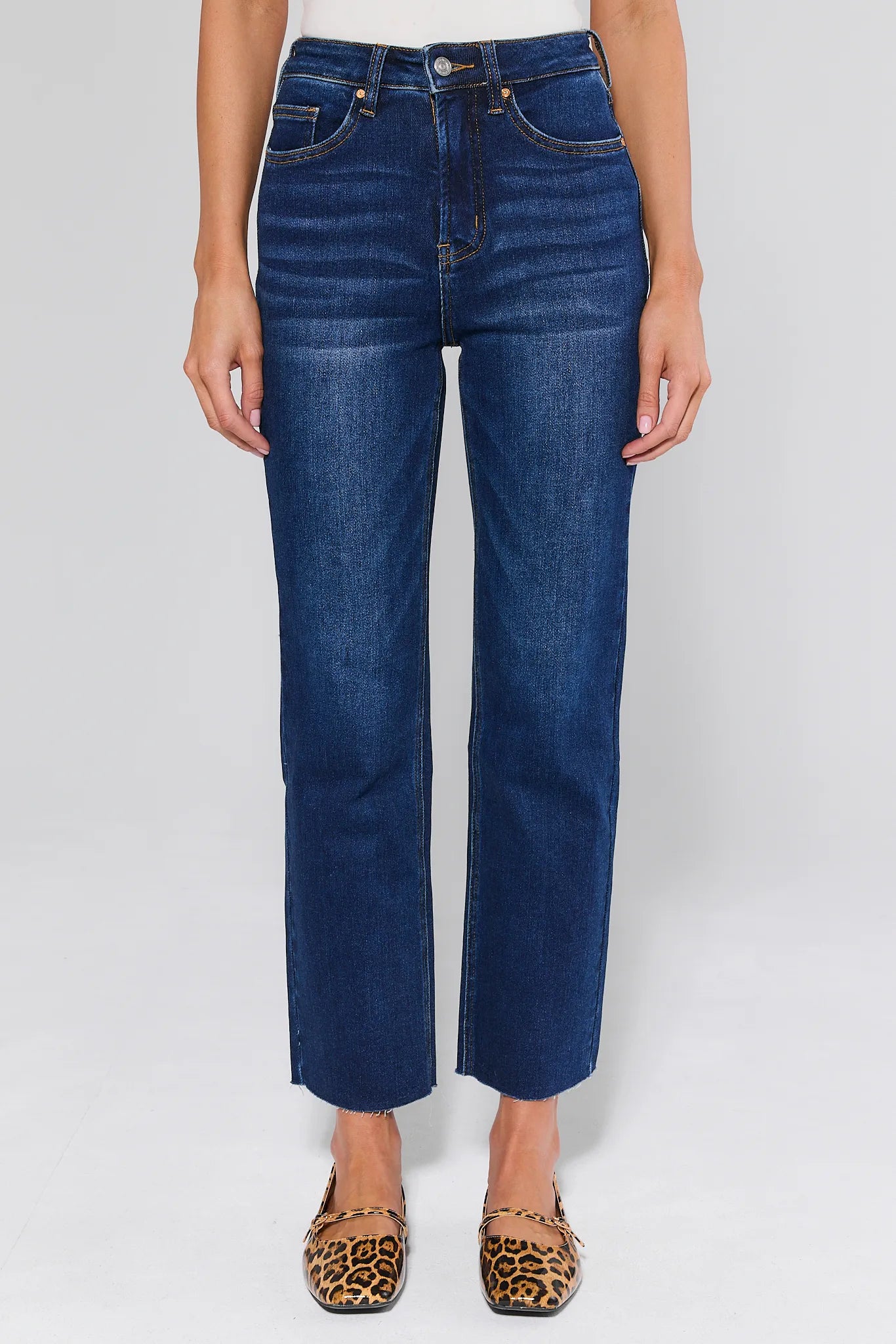 Person wearing Lucy Dark Wash Straight Leg Jeans on a white background
