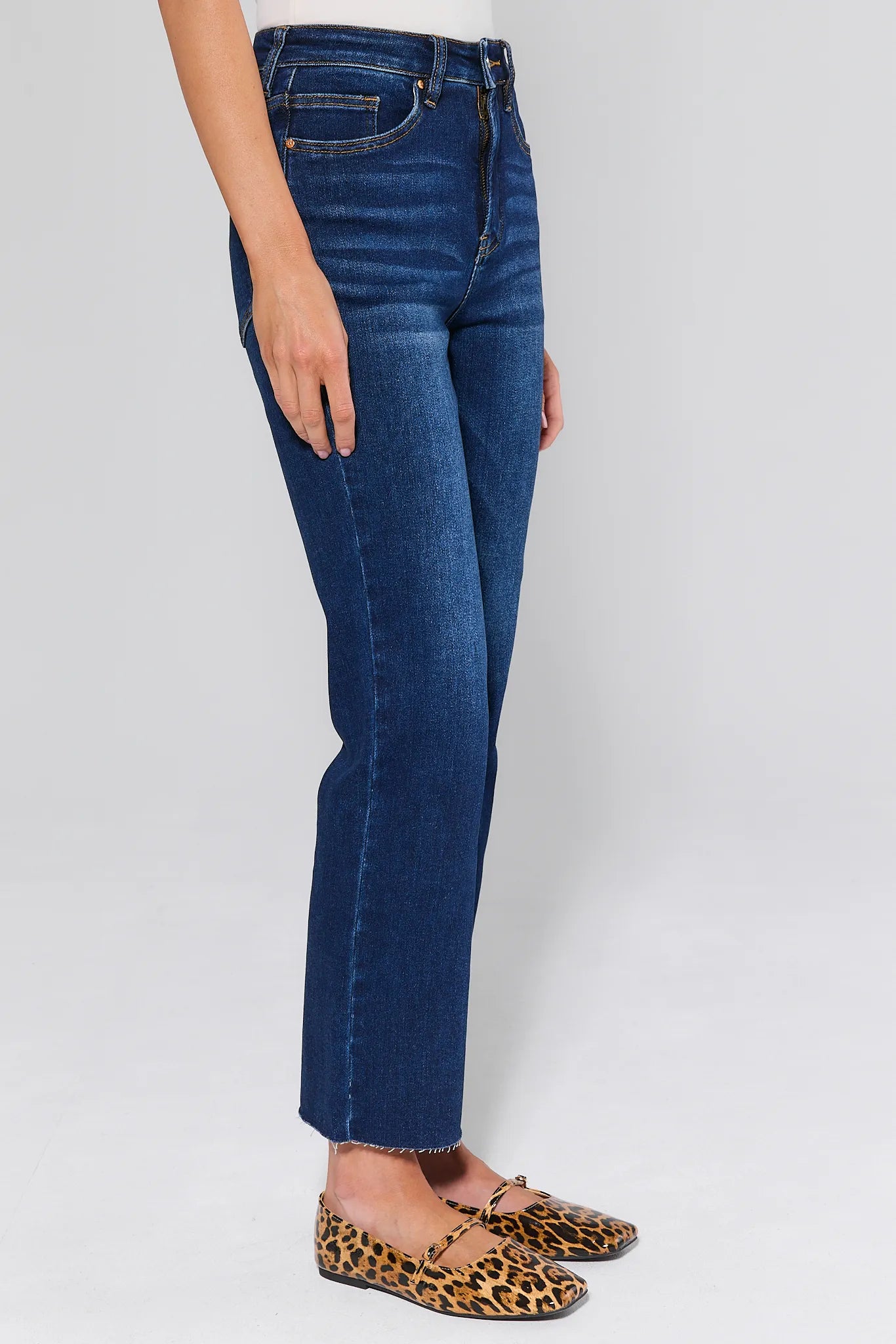 Person wearing Lucy Dark Wash Straight Leg Jeans on a white background