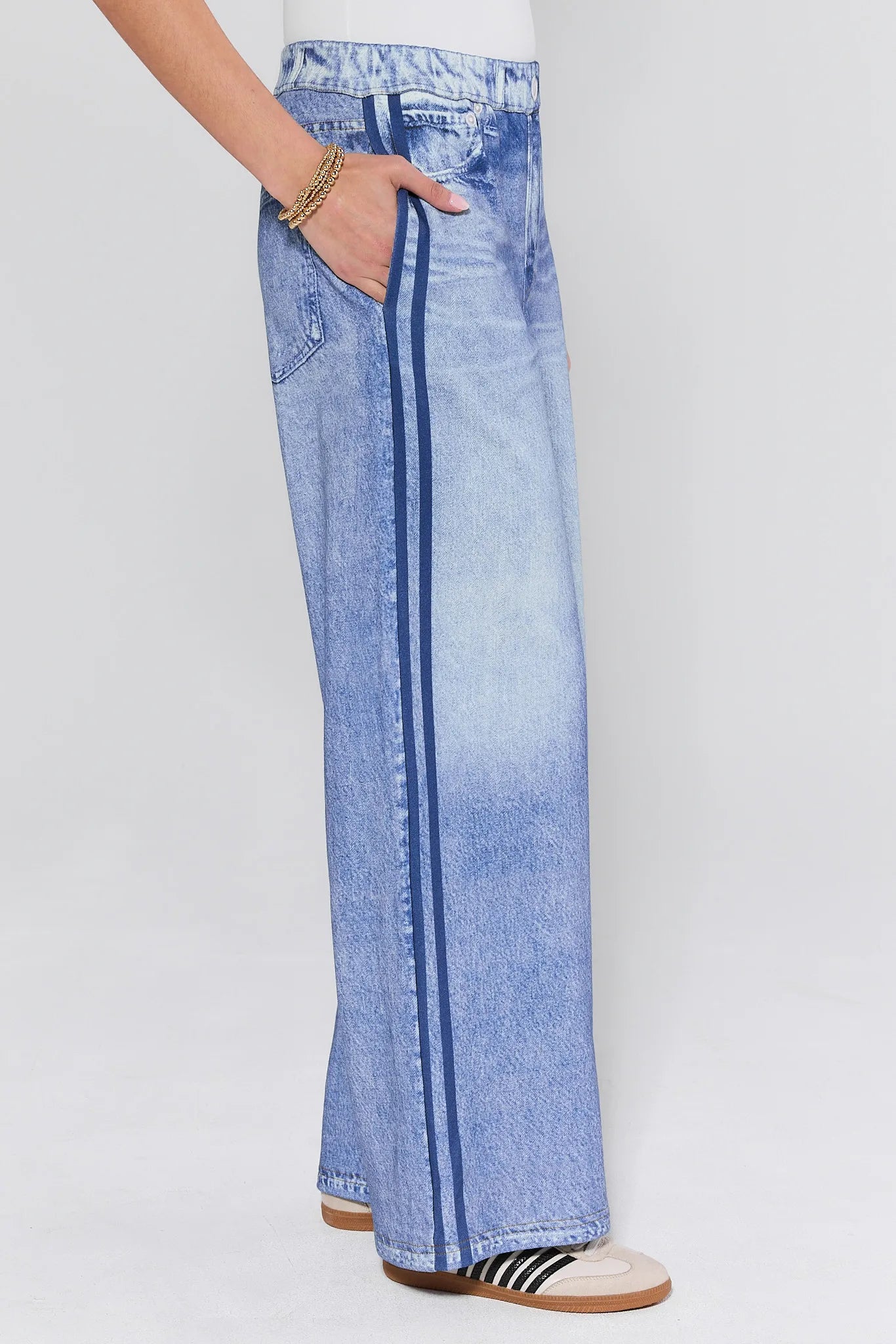 Light blue denim cotton jeans worn by a person on a white background