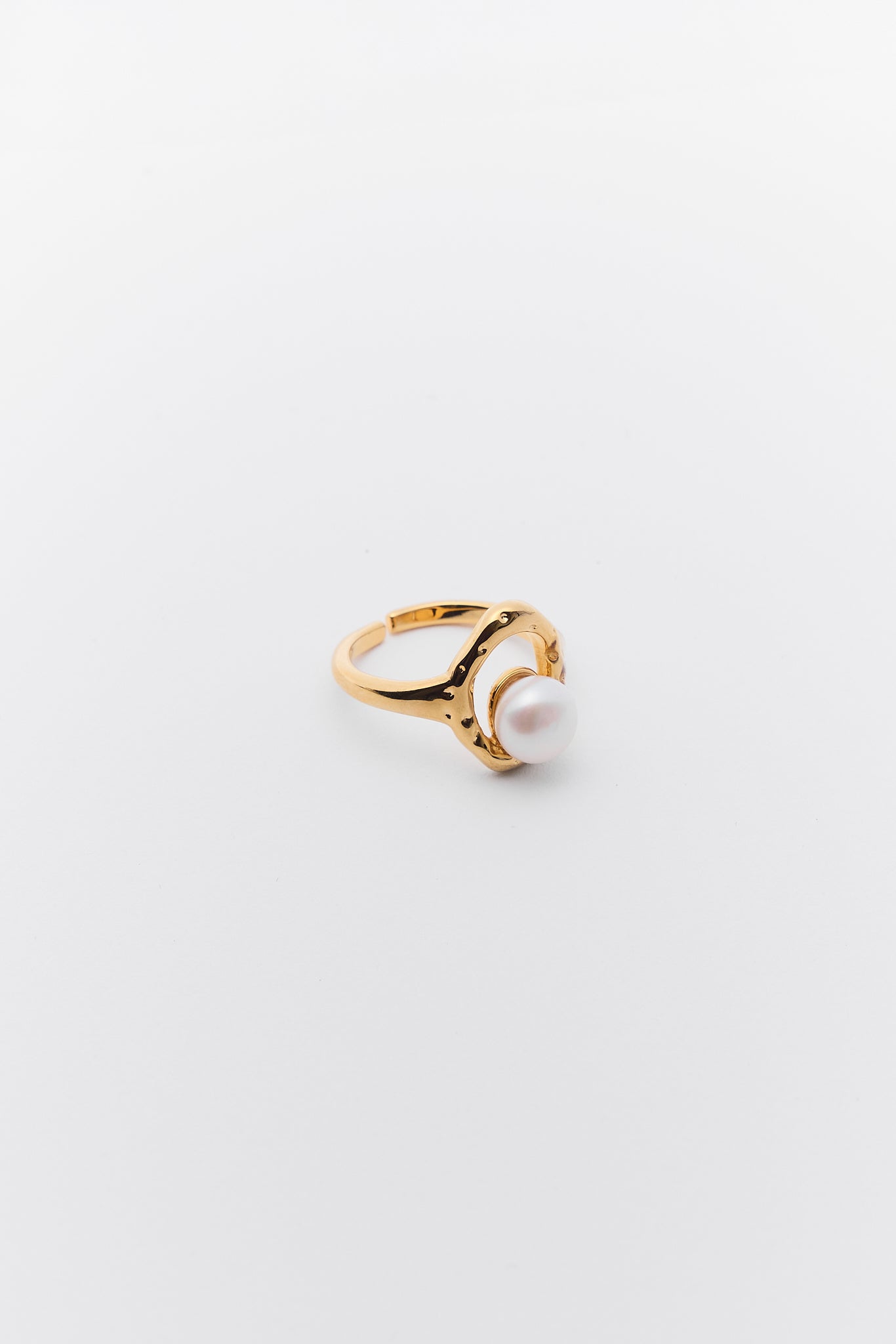 Gold ring with a pearl on a light gray background Margot Gold Pearl Ring 