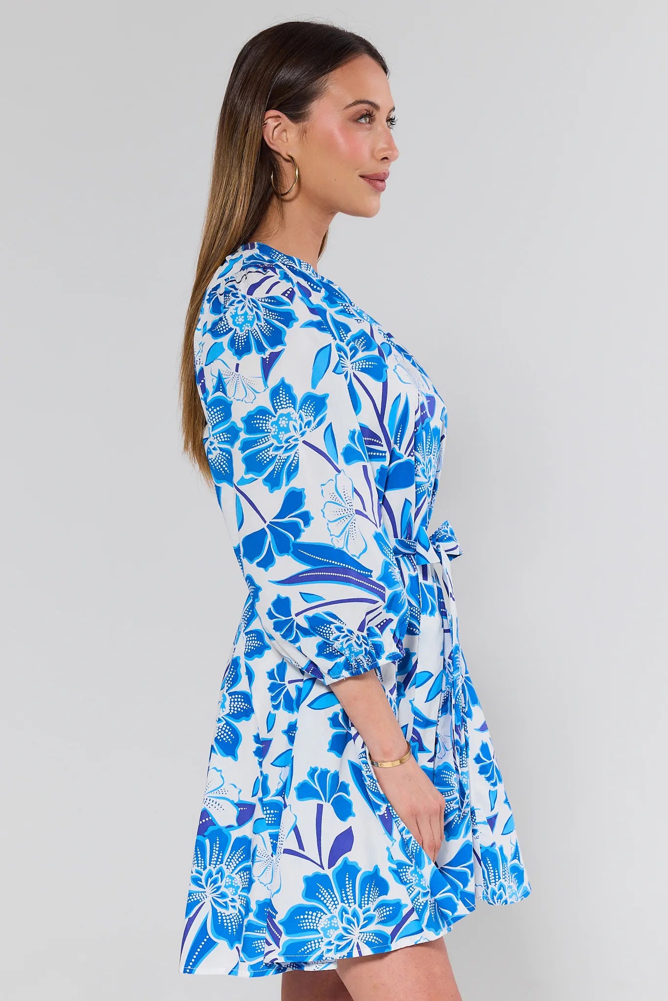 Woman wearing a blue dress on a gray background