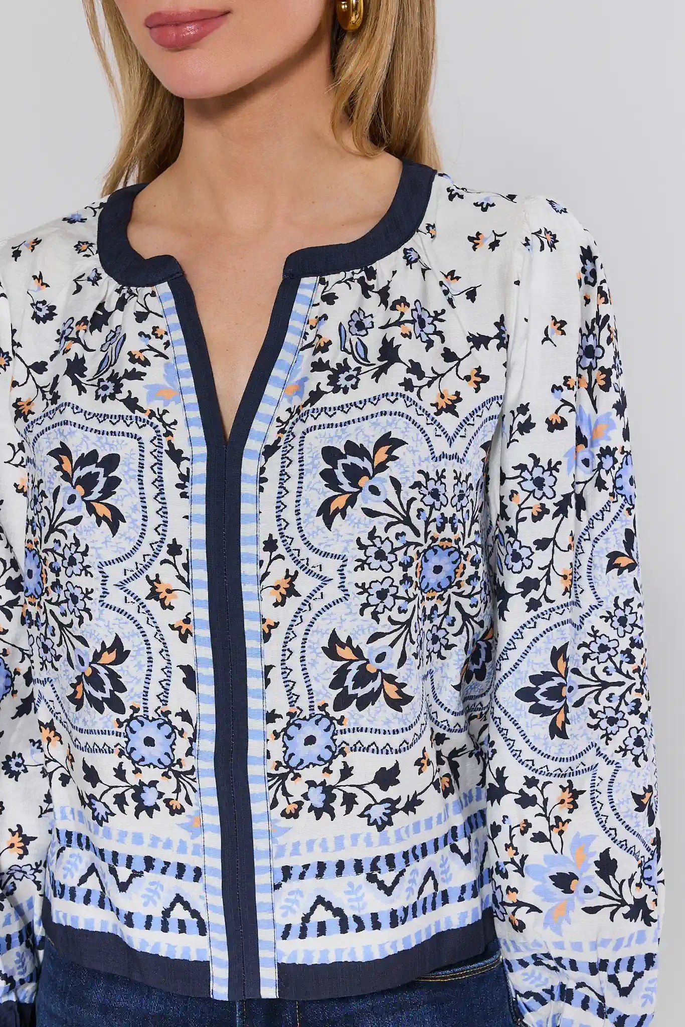Close-up of a patterned blouse with a neutral background