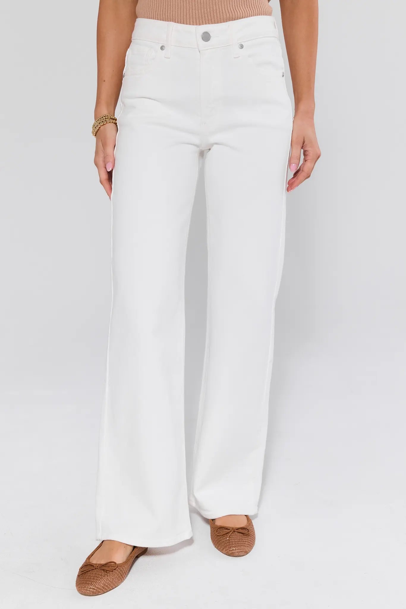 White wide-leg pants worn by a person on a white background