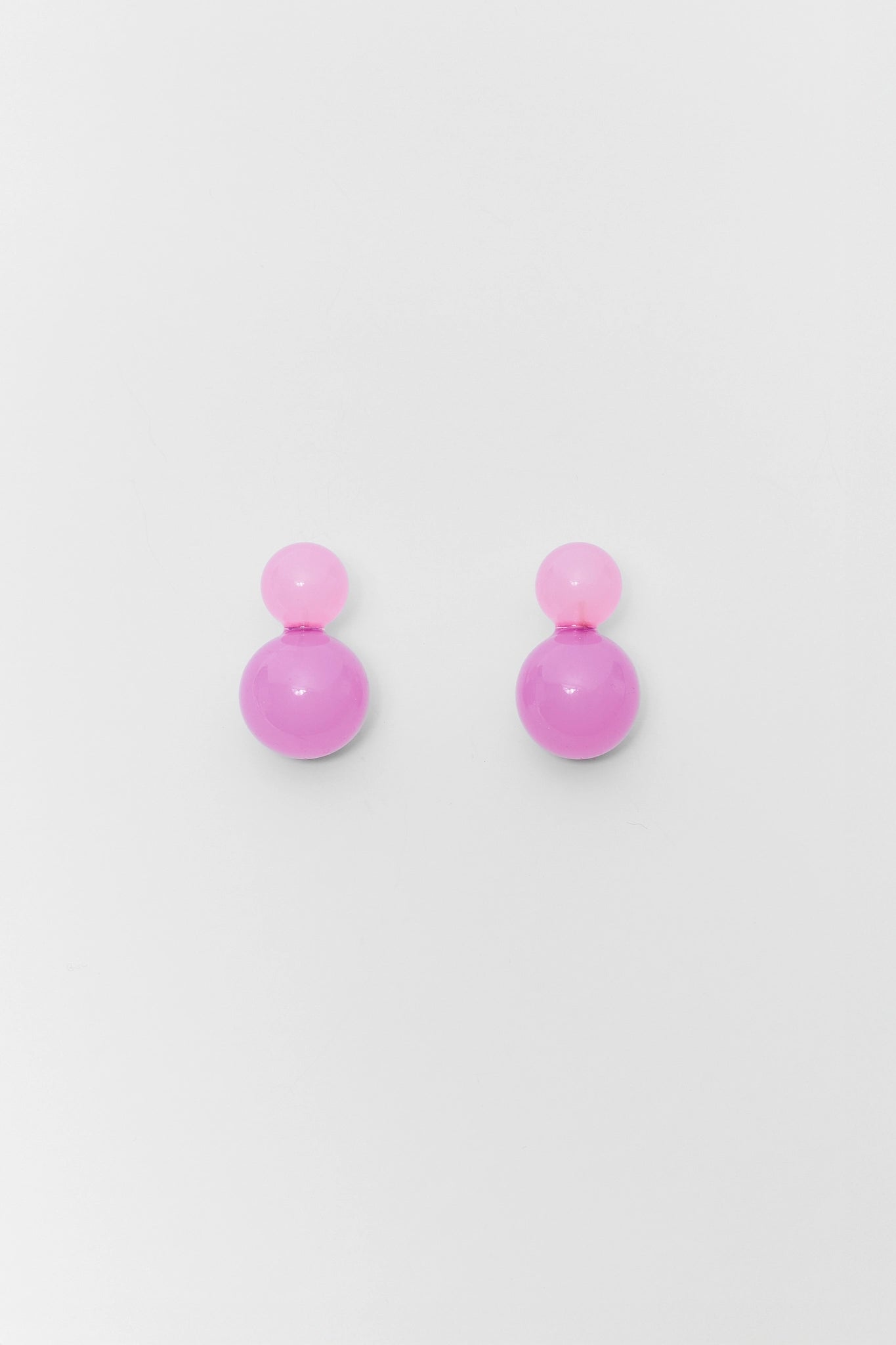 Pair of pink earrings on a light gray background