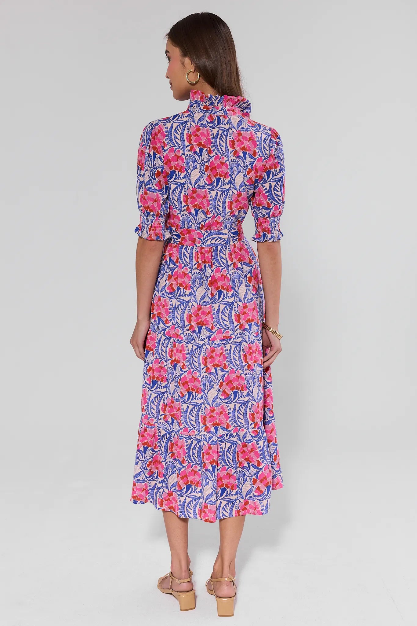 Woman wearing a floral dress on a plain background