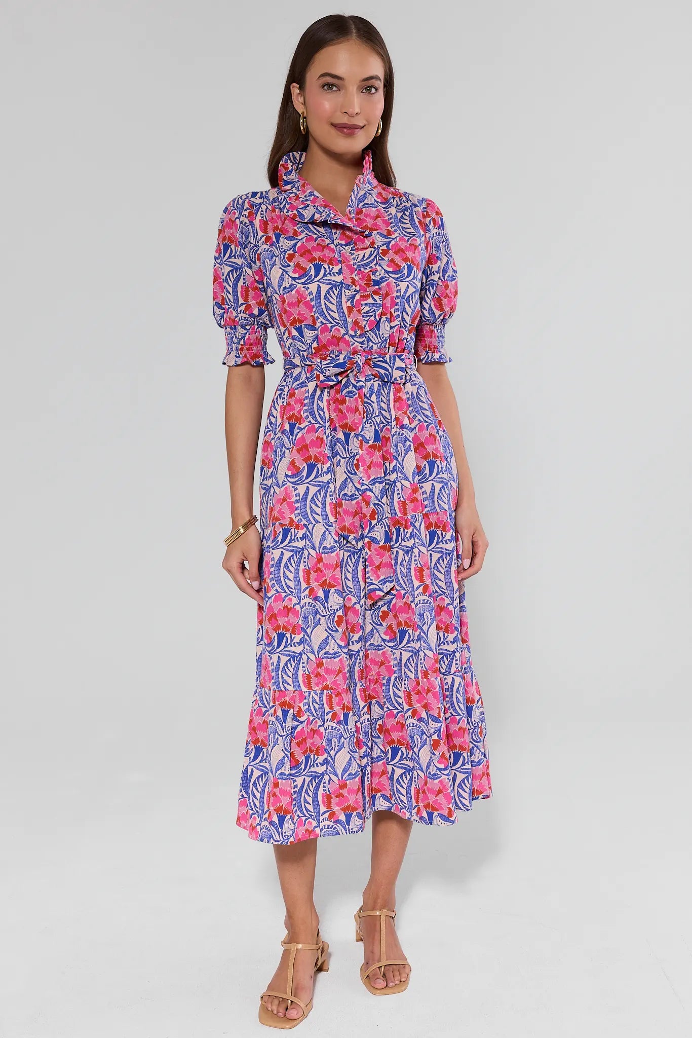 Woman wearing a floral dress on a plain background