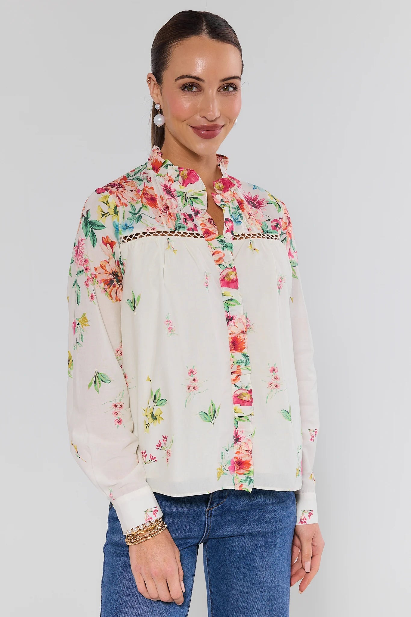 Woman wearing a floral blouse with a white background