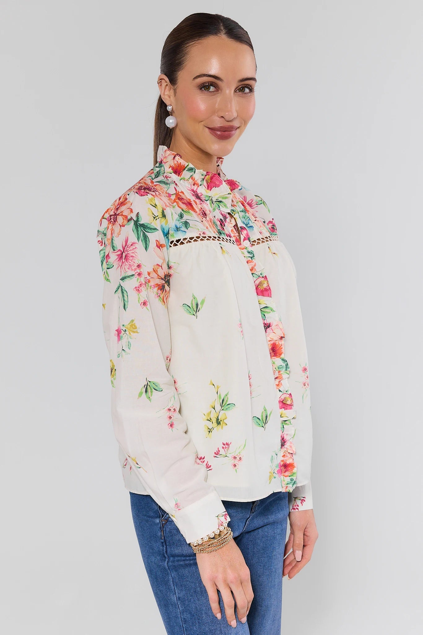 Woman wearing a floral blouse with a plain background