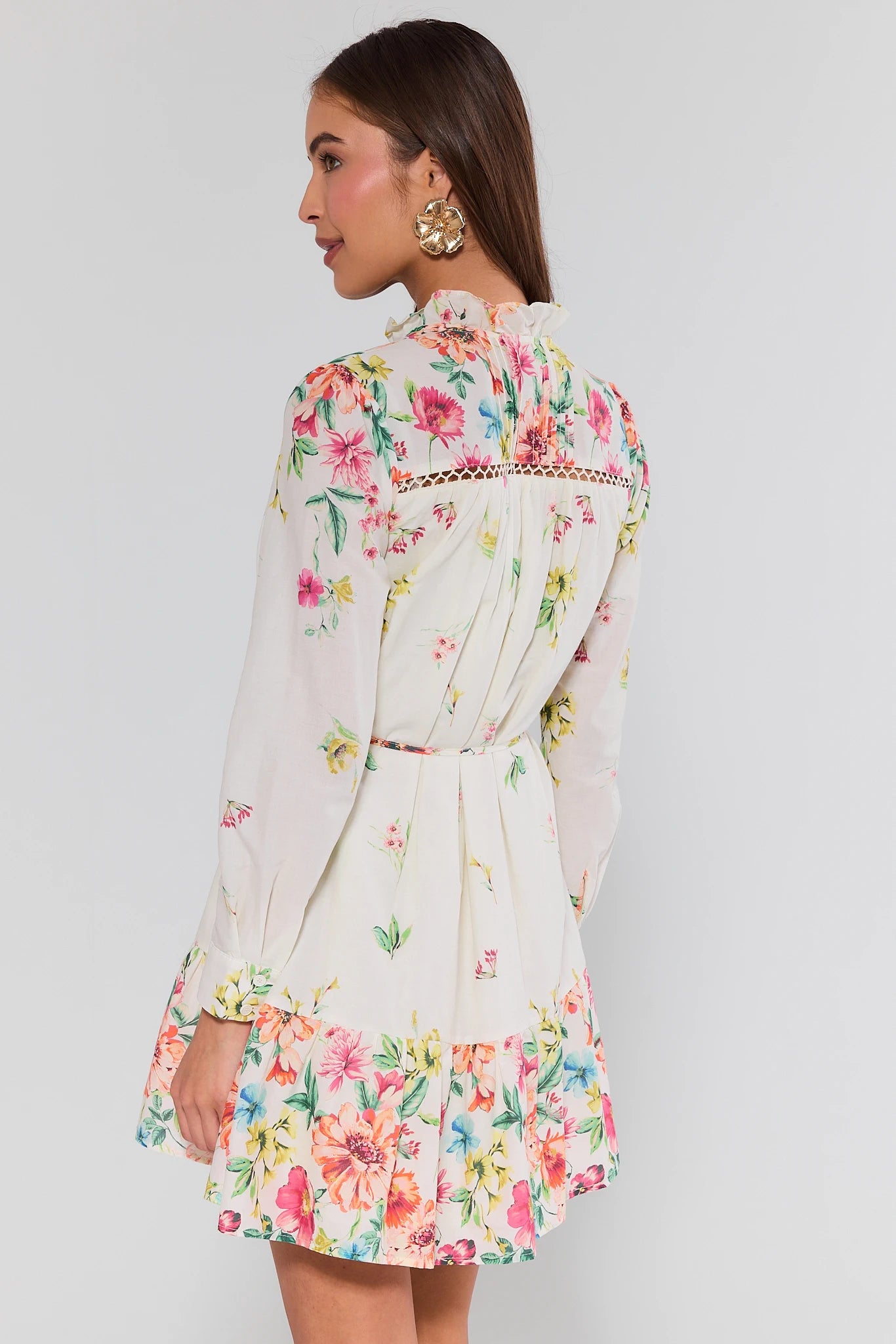 Woman wearing a floral dress with a plain background