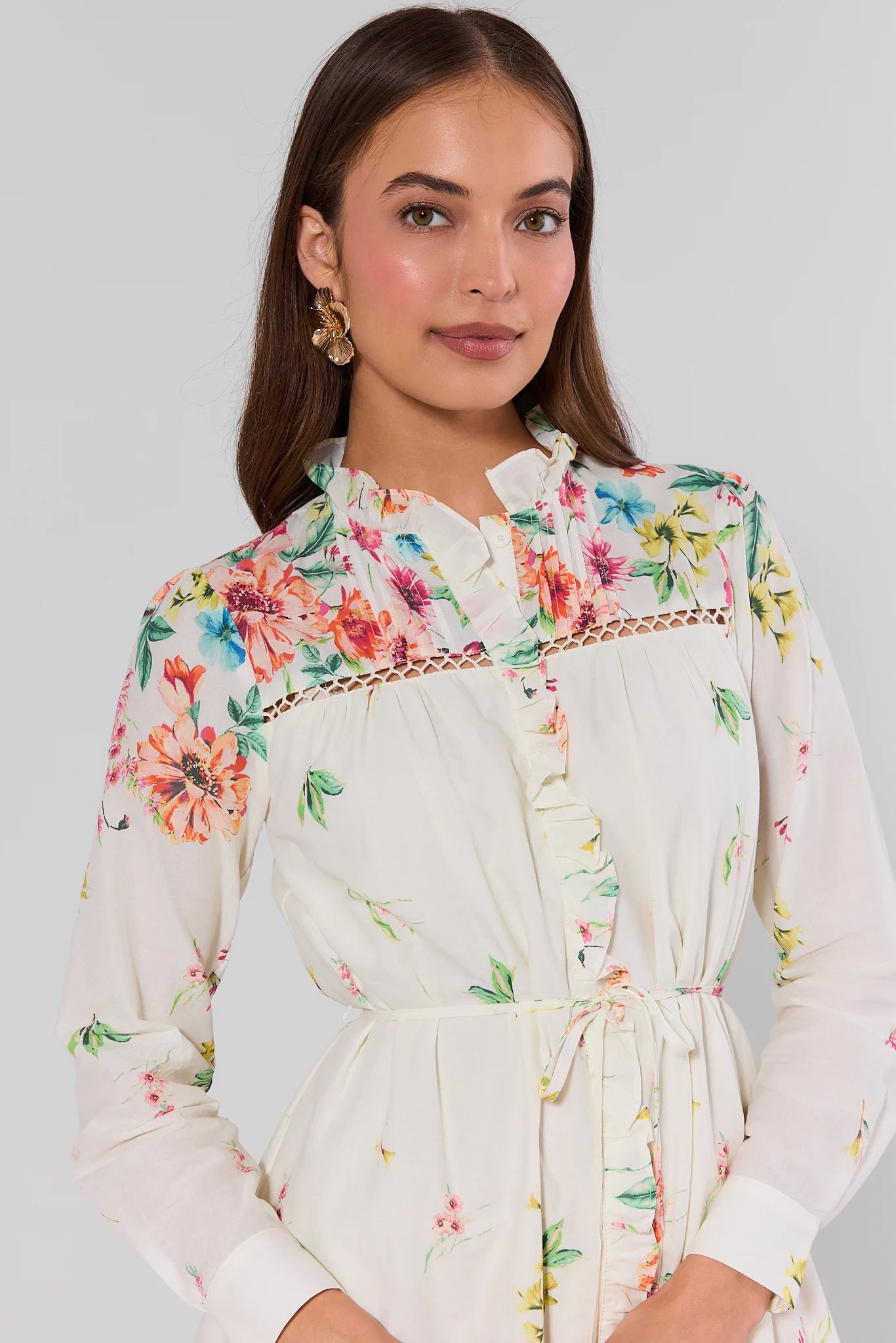 Woman wearing a floral dress with a plain background