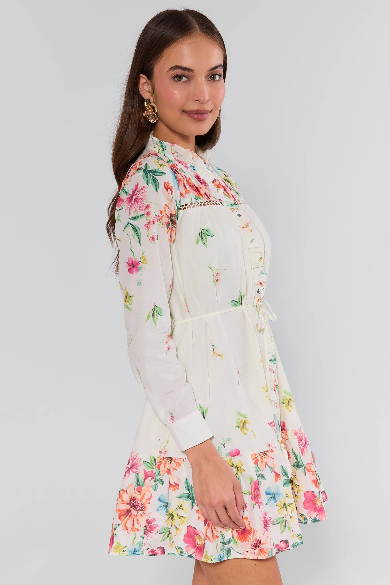 Woman wearing a floral dress with a plain background