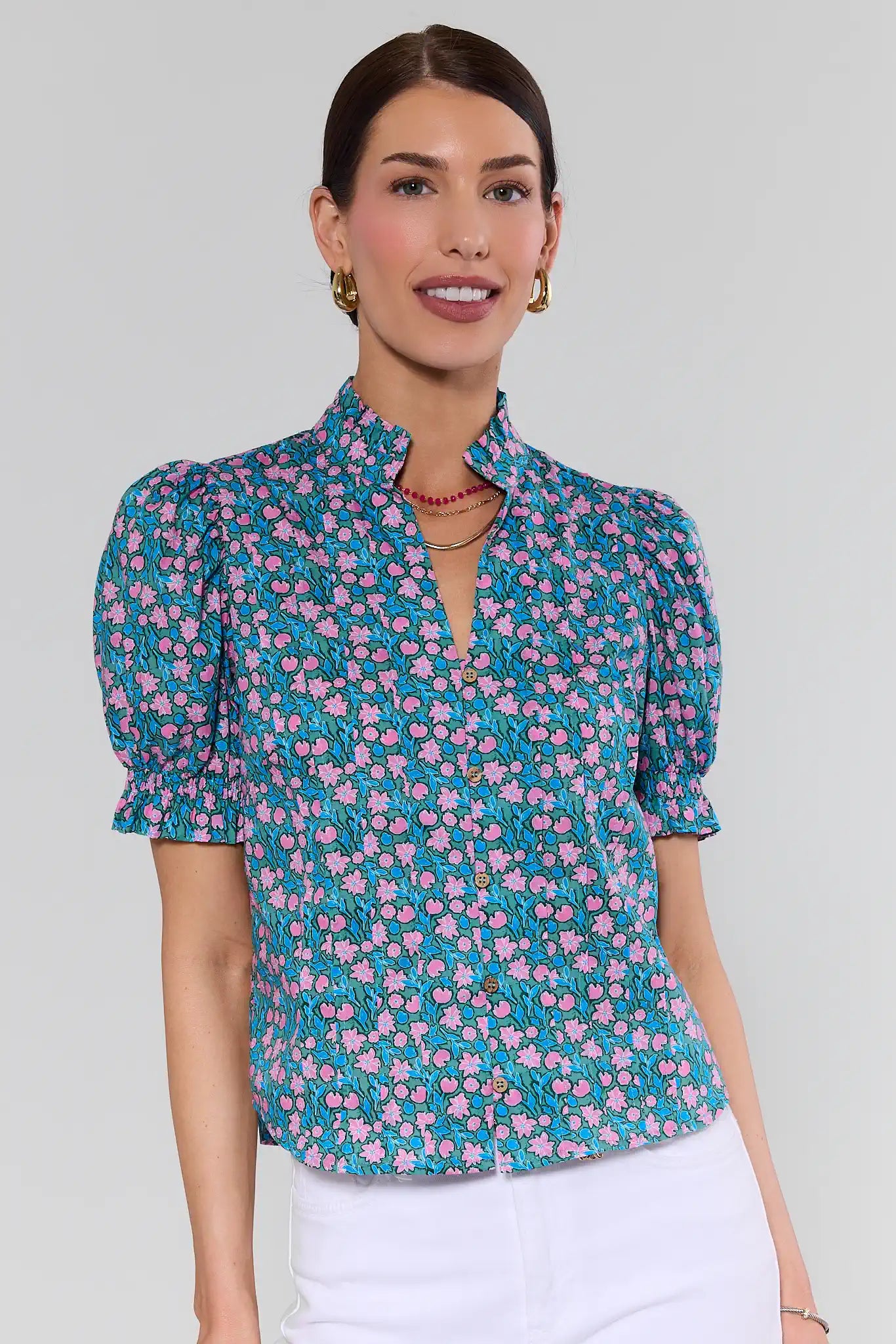Woman wearing a floral blouse with a plain background