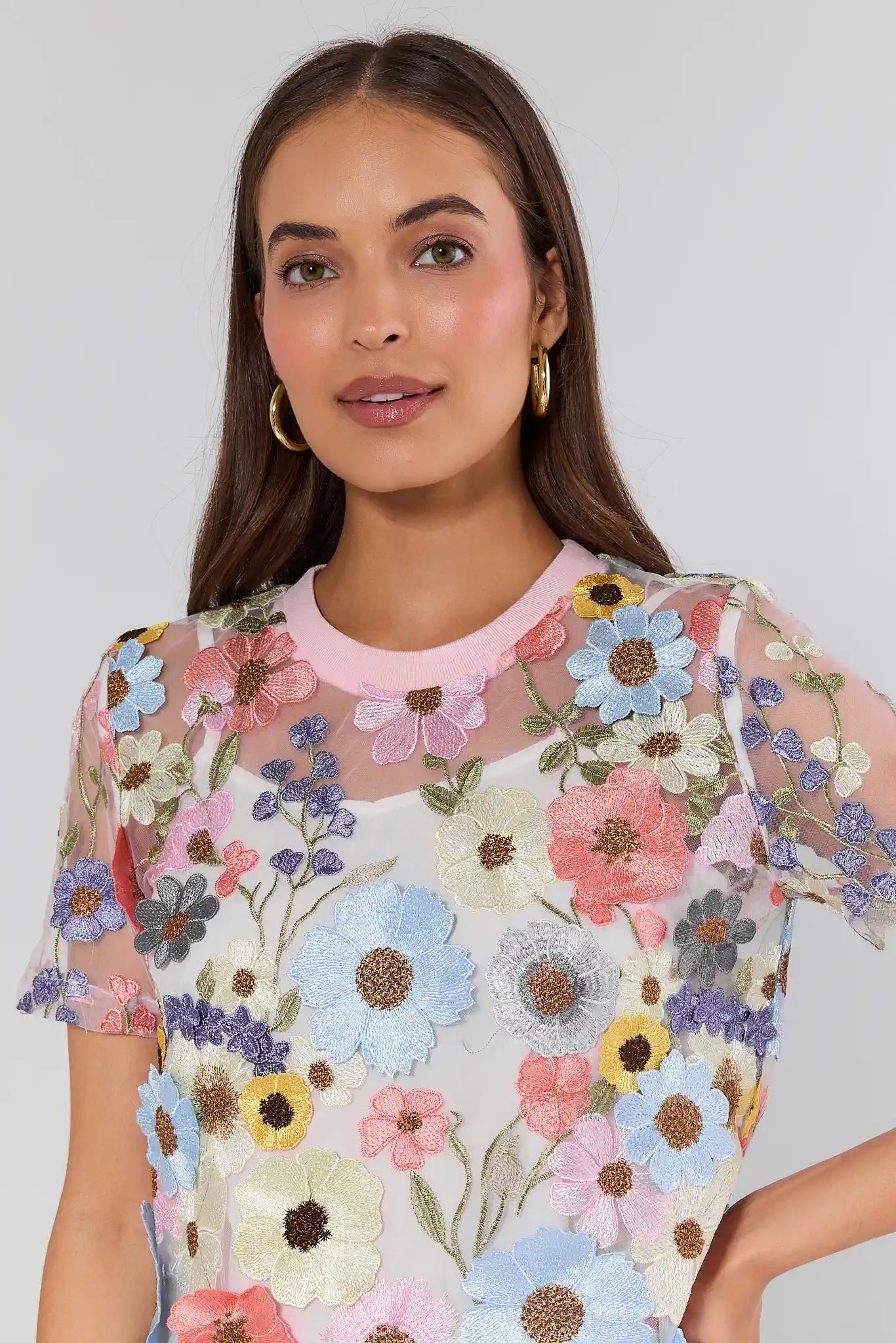 Woman wearing a floral dress with a plain background