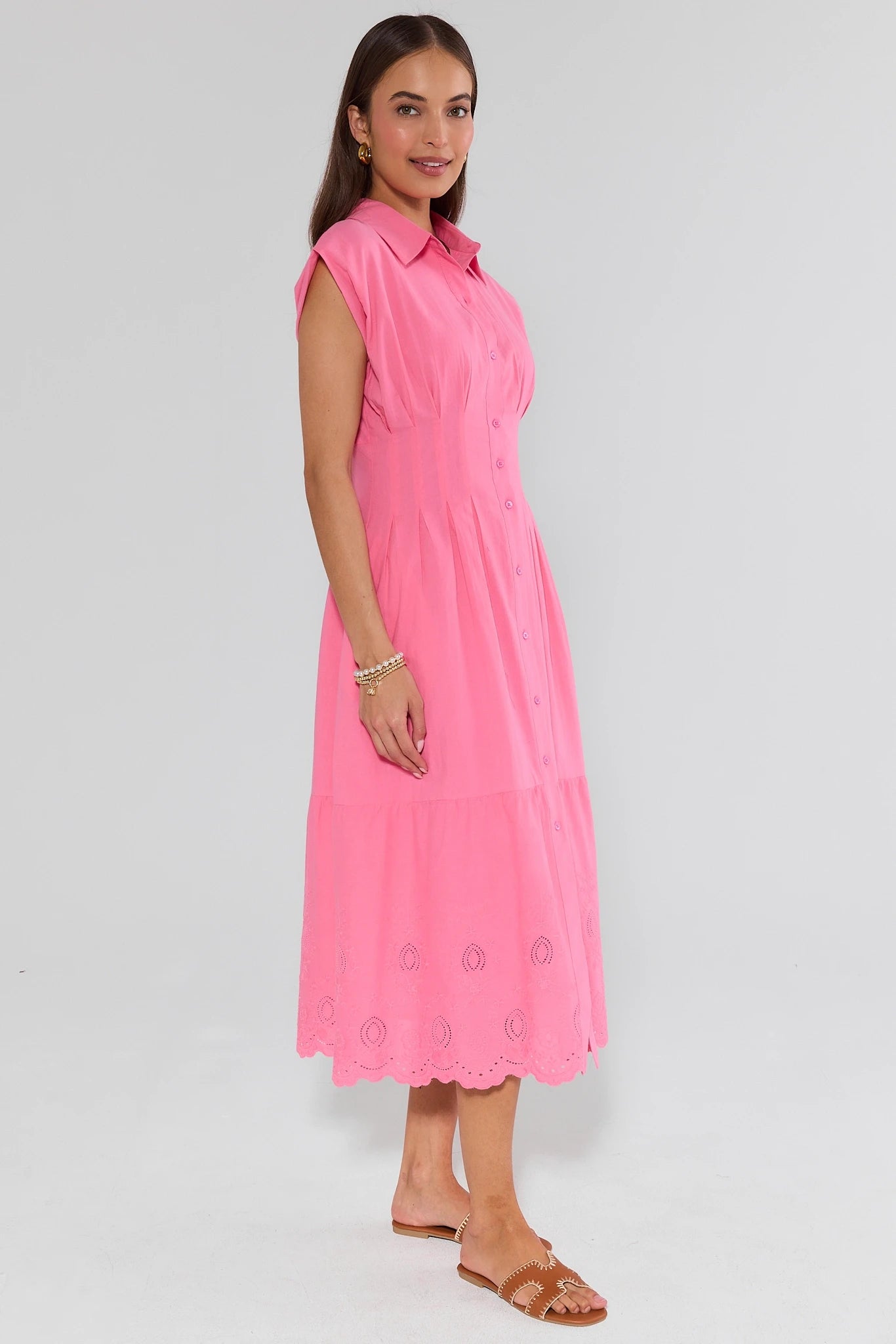 Woman wearing a pink dress with a white background