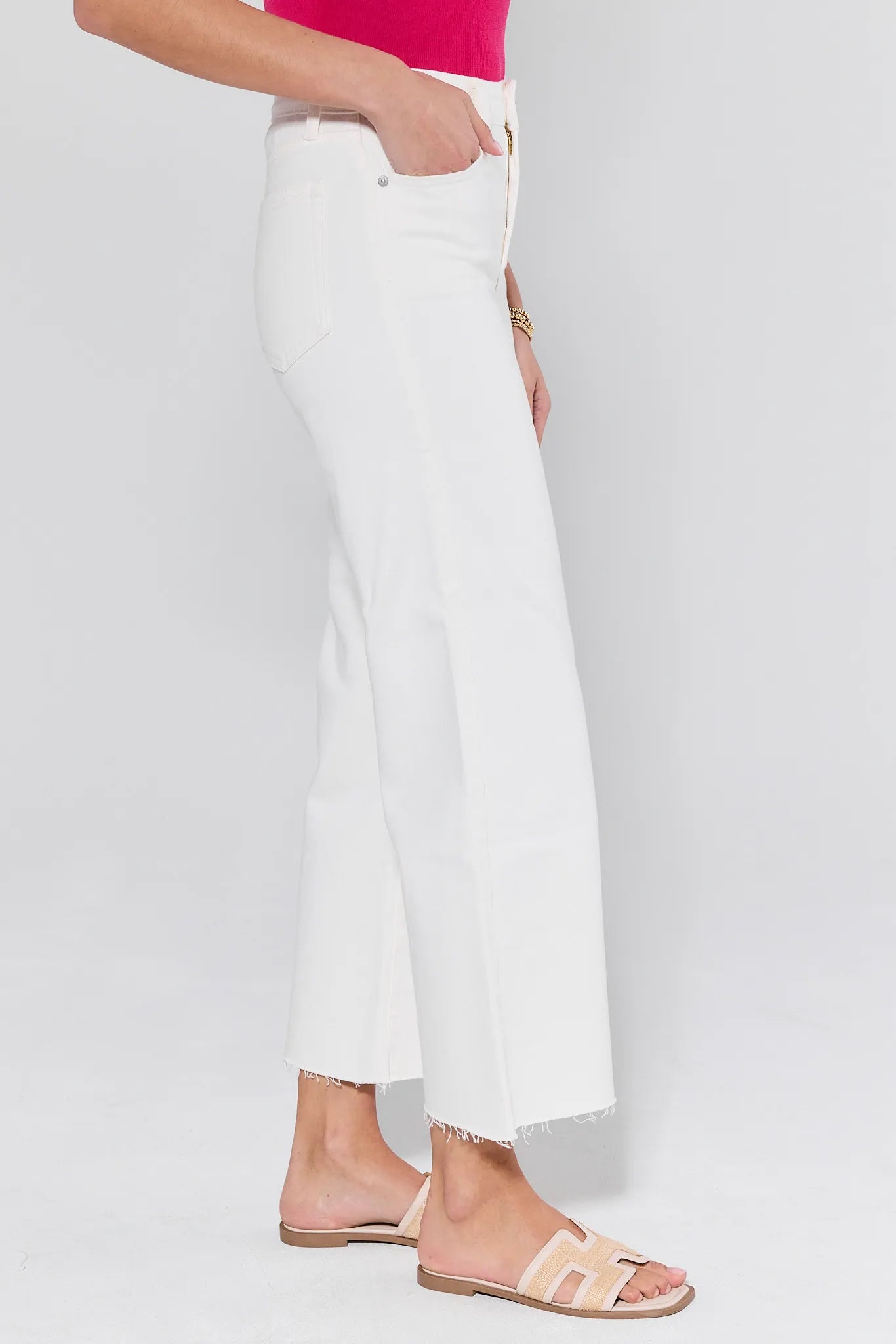 White pants worn by a person on a white background