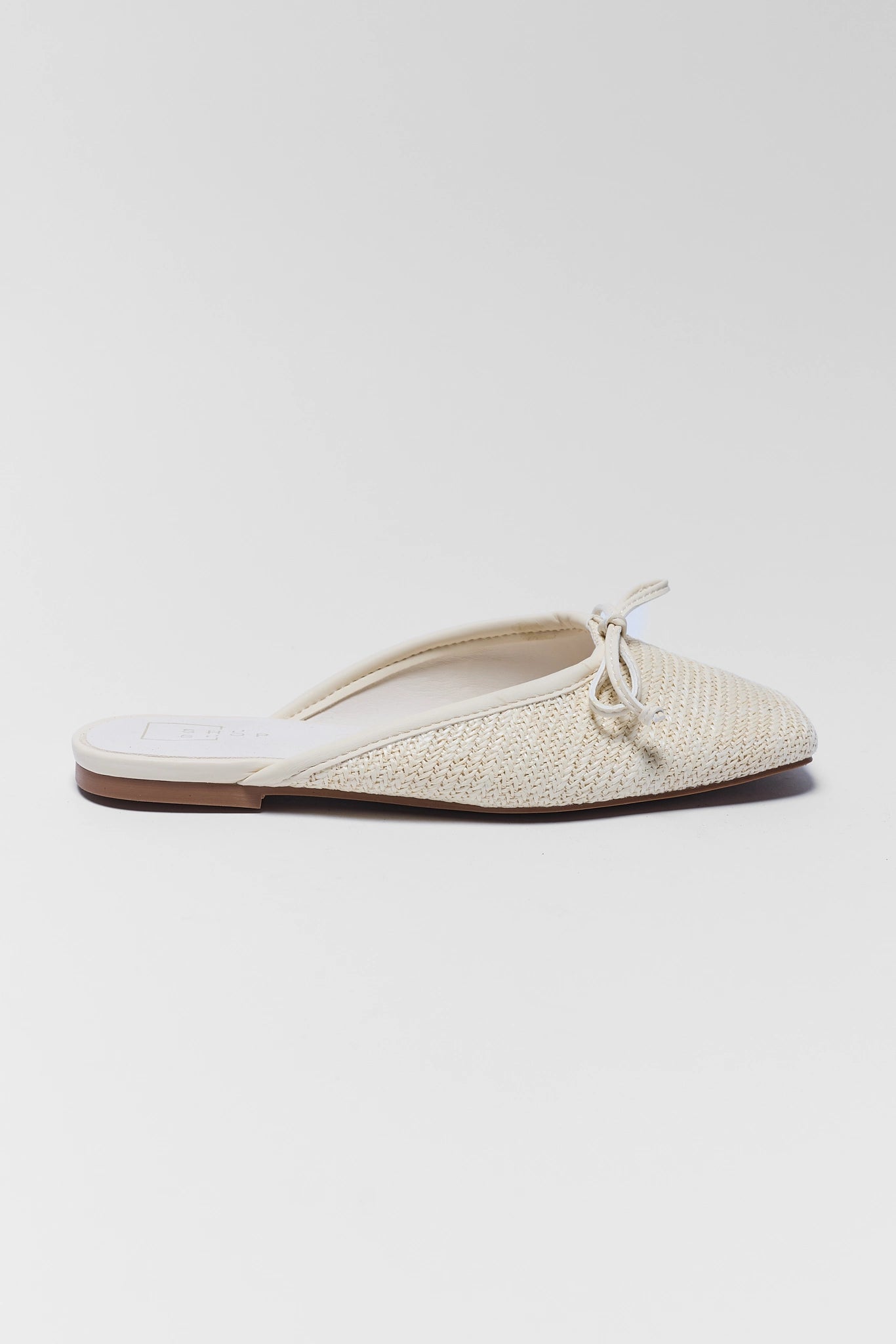 Beige woven slipper with a white sole on a light gray background