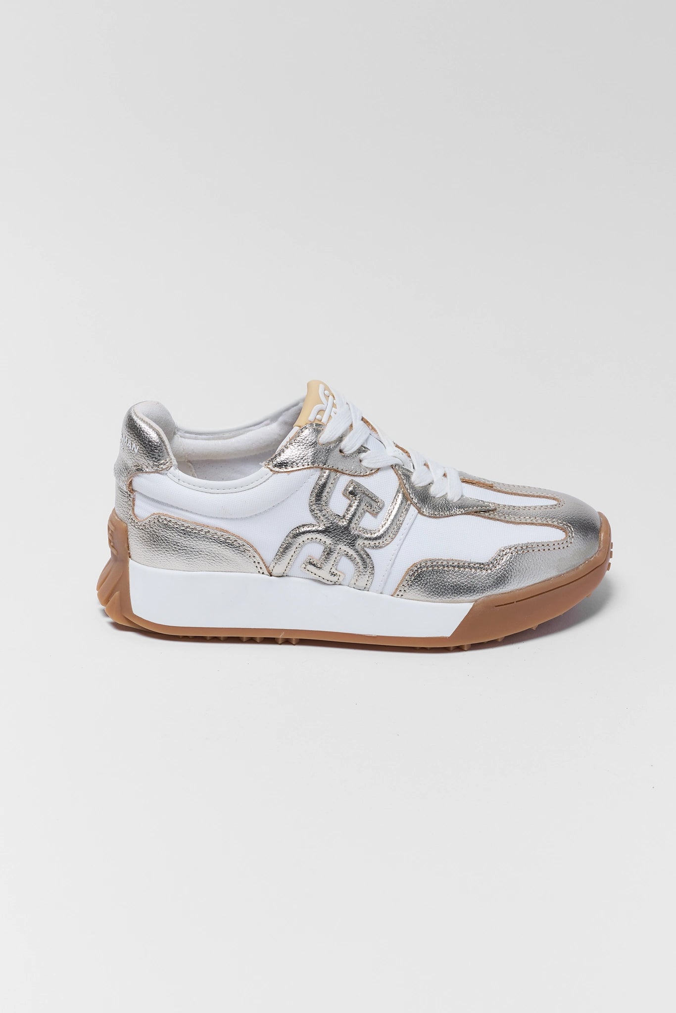 White sneaker with silver accents on a light gray background