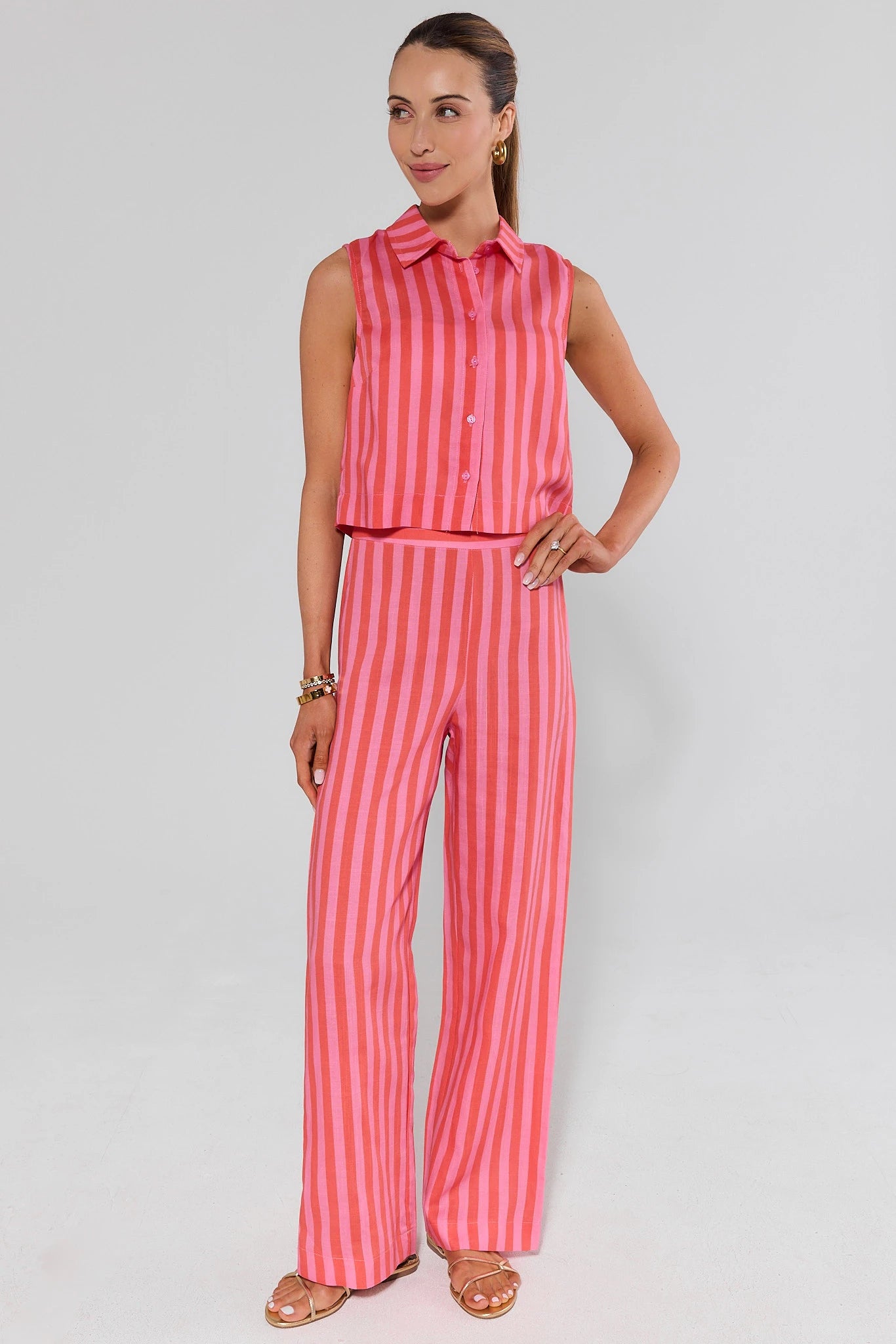 Woman wearing a red and pink striped outfit on a background