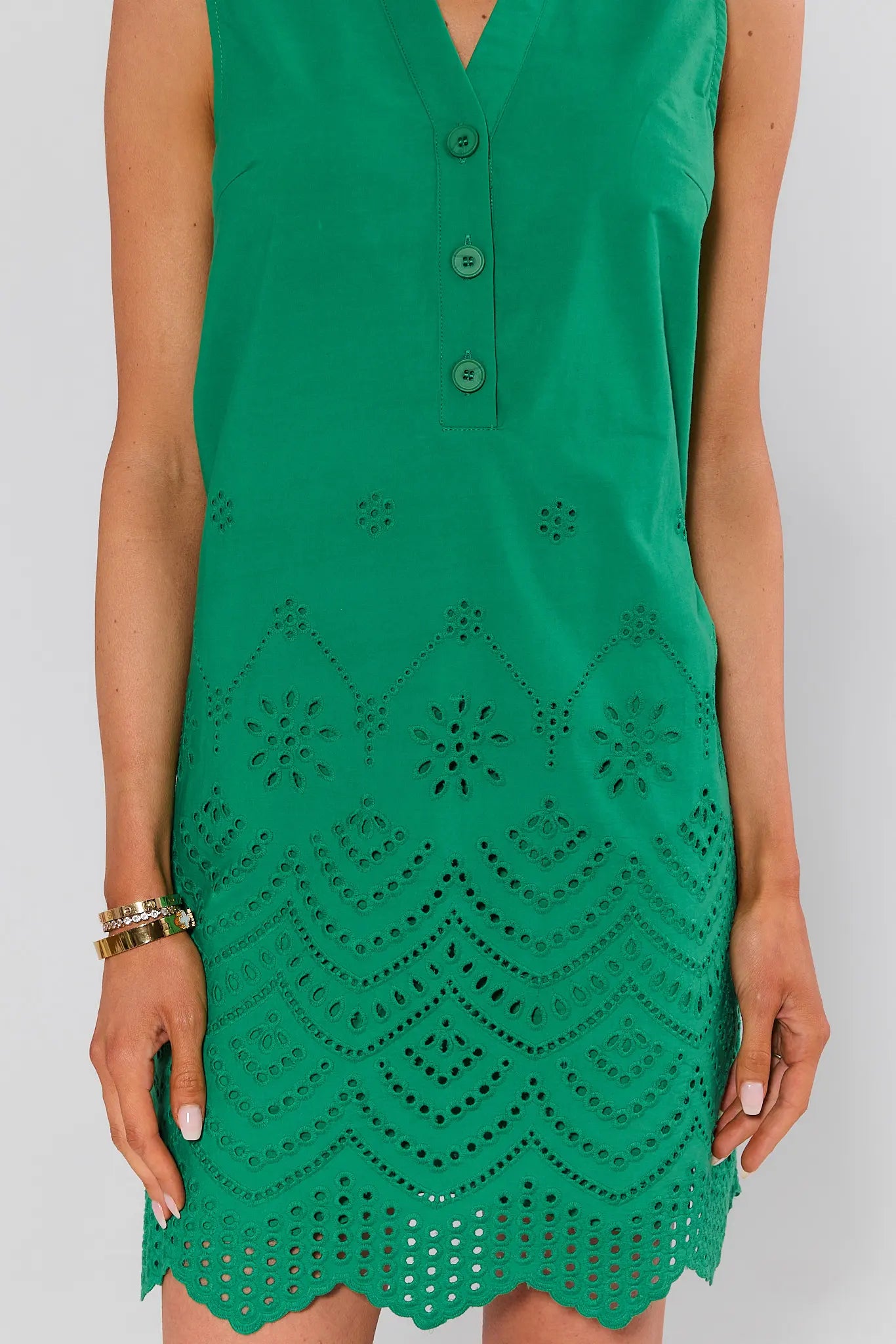 close up Green dress with intricate cut-out pattern on a white background