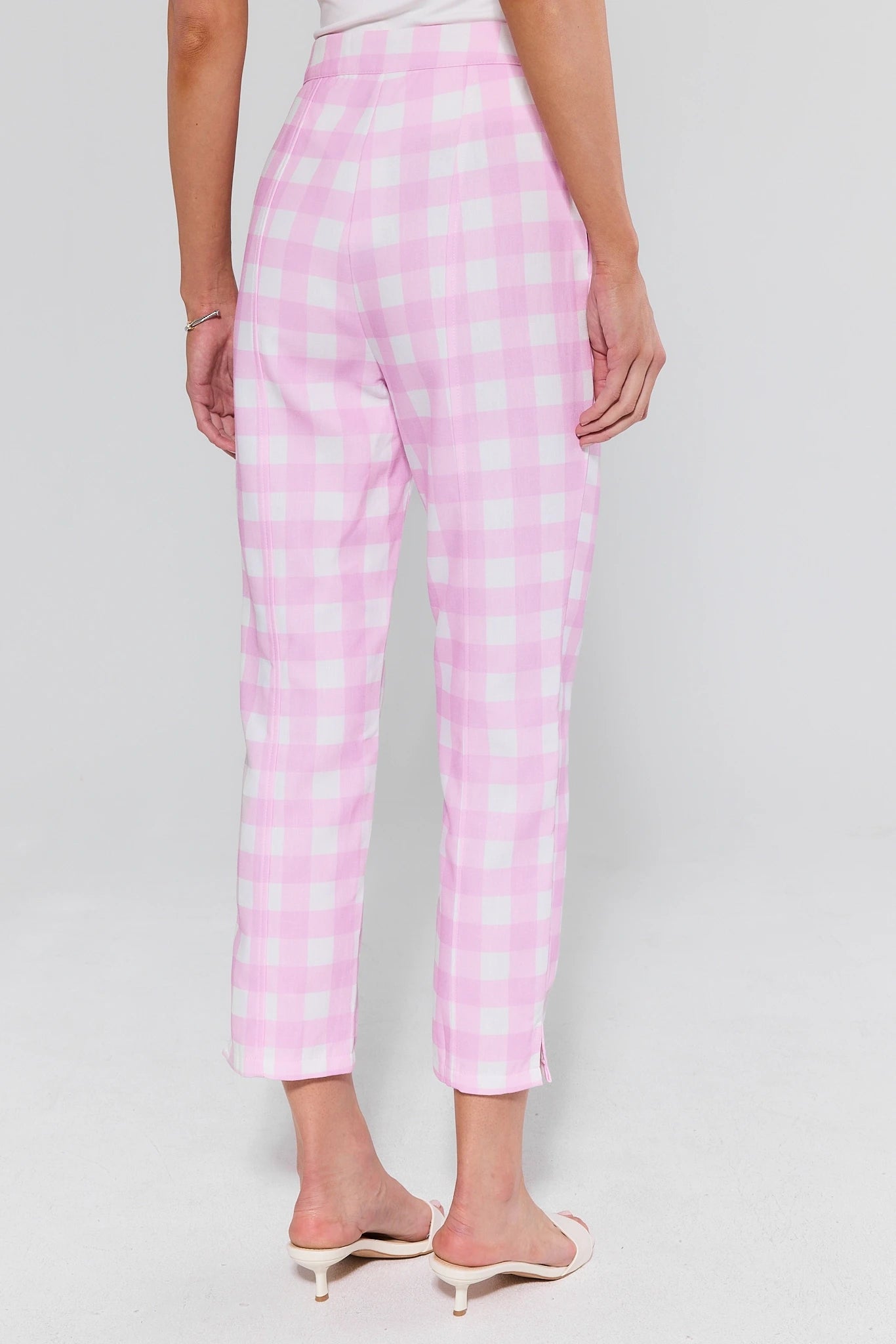 Pink checkered pants worn by a person on a background