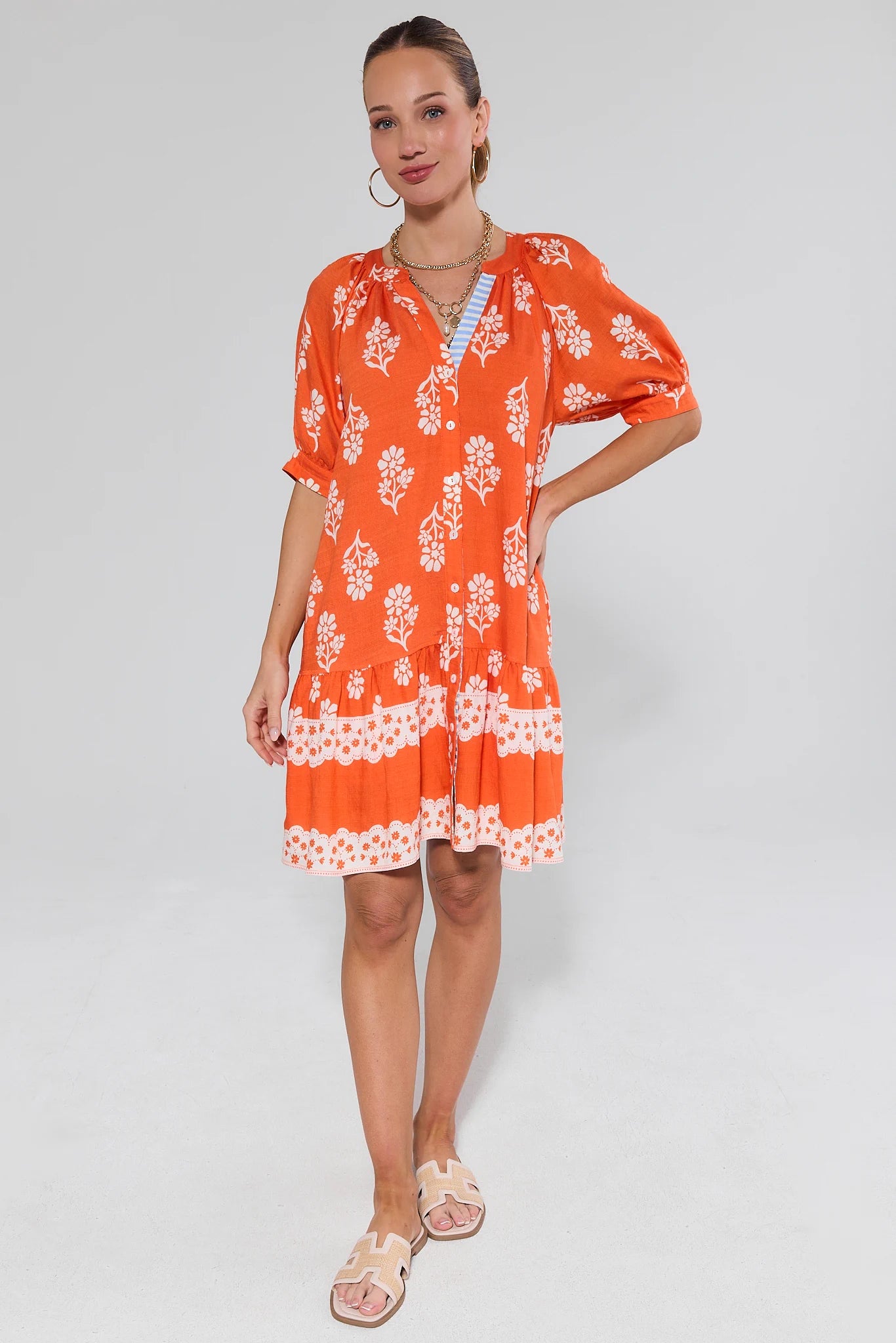 Woman wearing an orange dress on a background