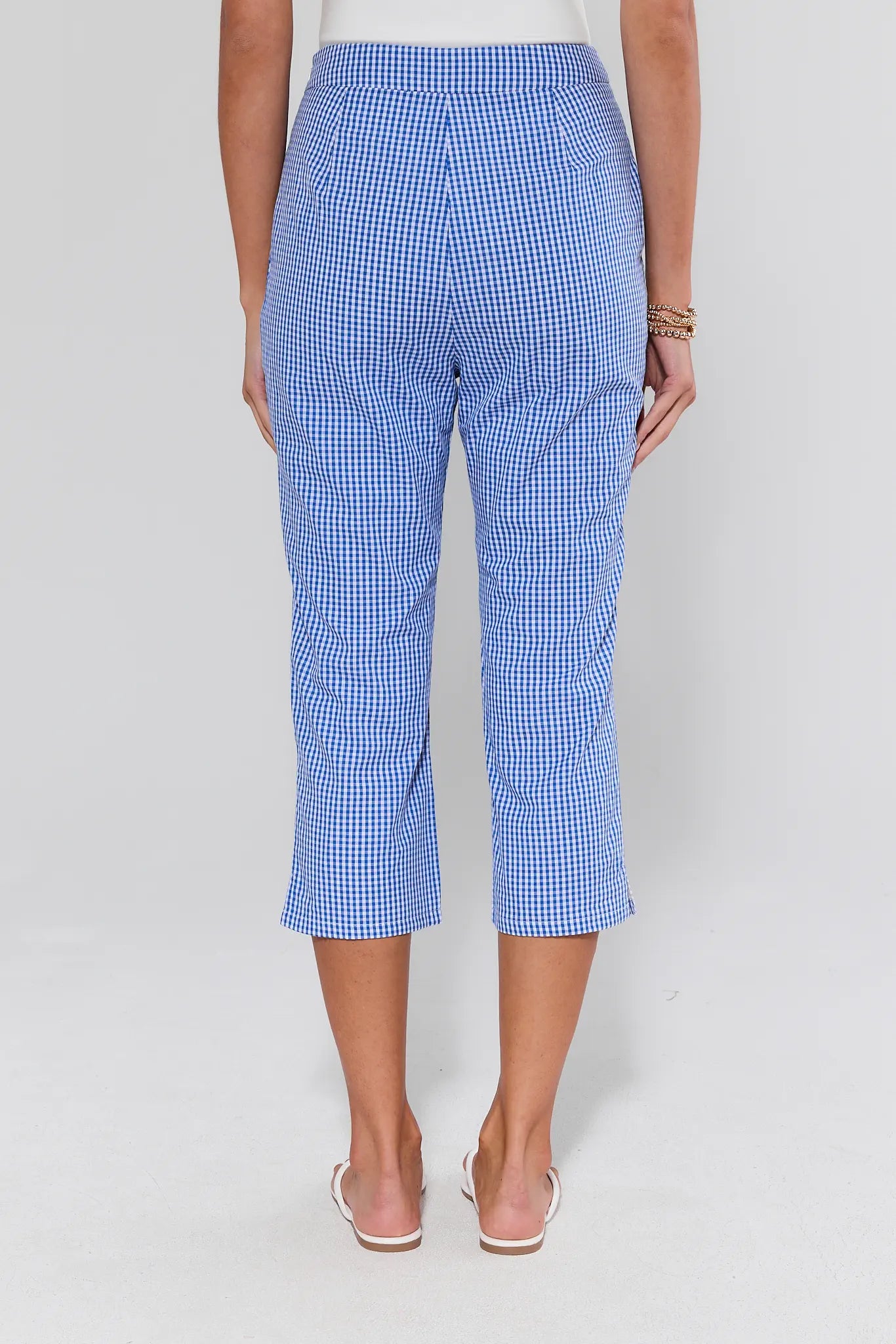 Blue checkered pants worn by a person on a white background