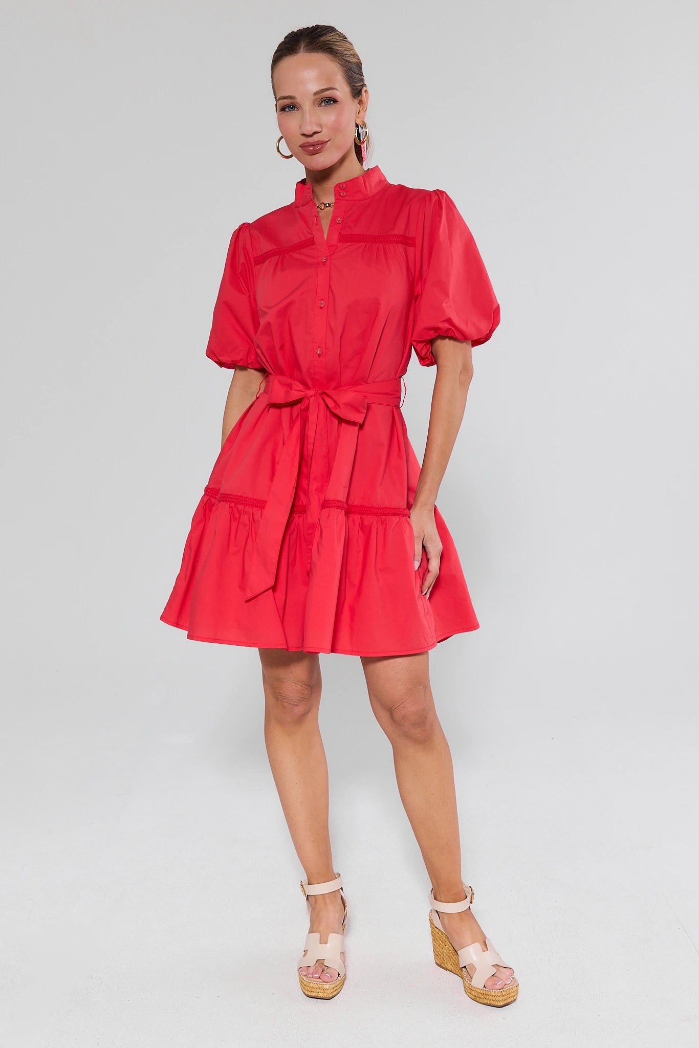 Jane Red Puff Sleeve Short Dress with mandarin collar, button-up front, puff sleeves, self-tie belt, tiered skirt. Paired with espadrille wedges and hoop earrings.