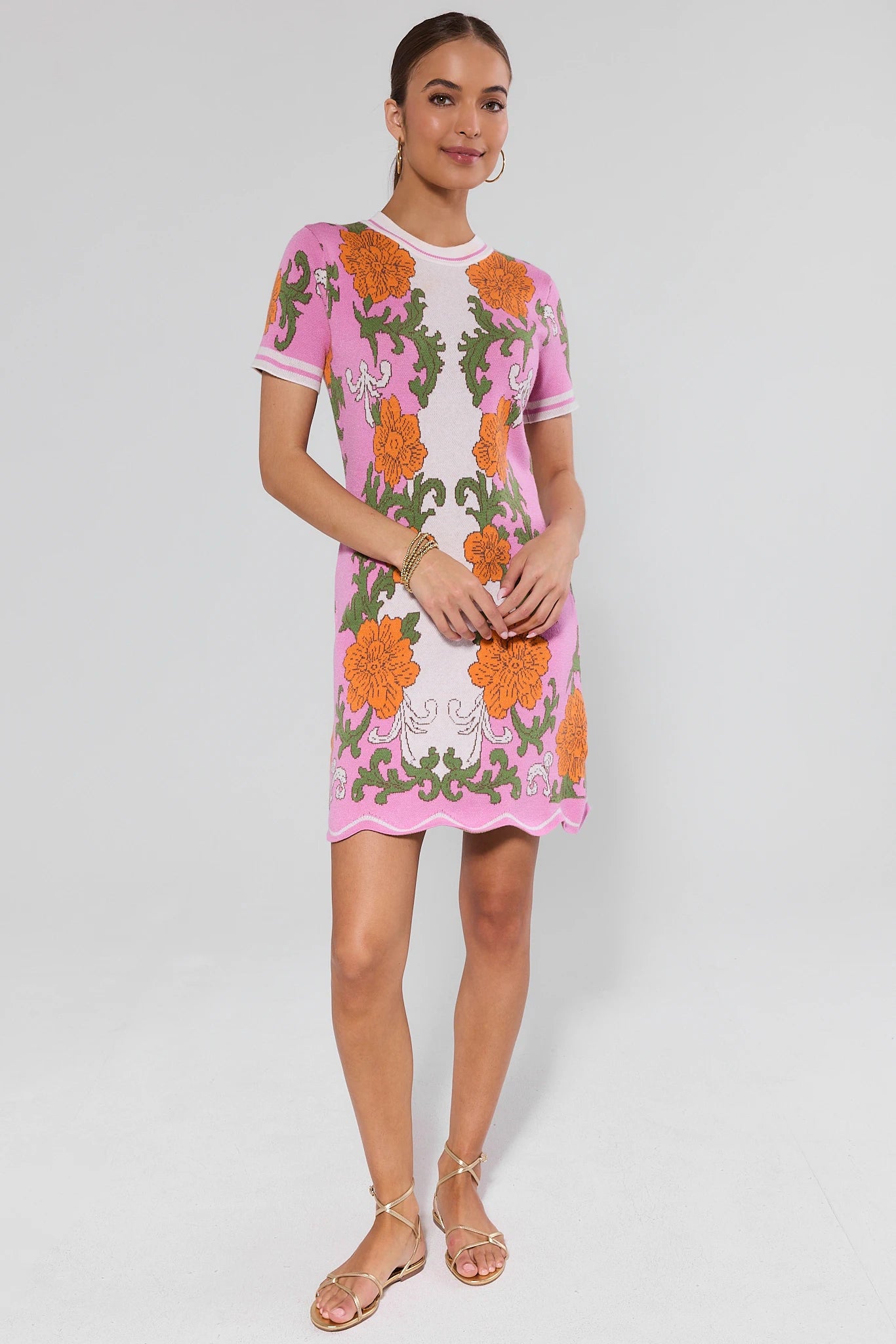 Woman wearing a pink floral dress on a white background
