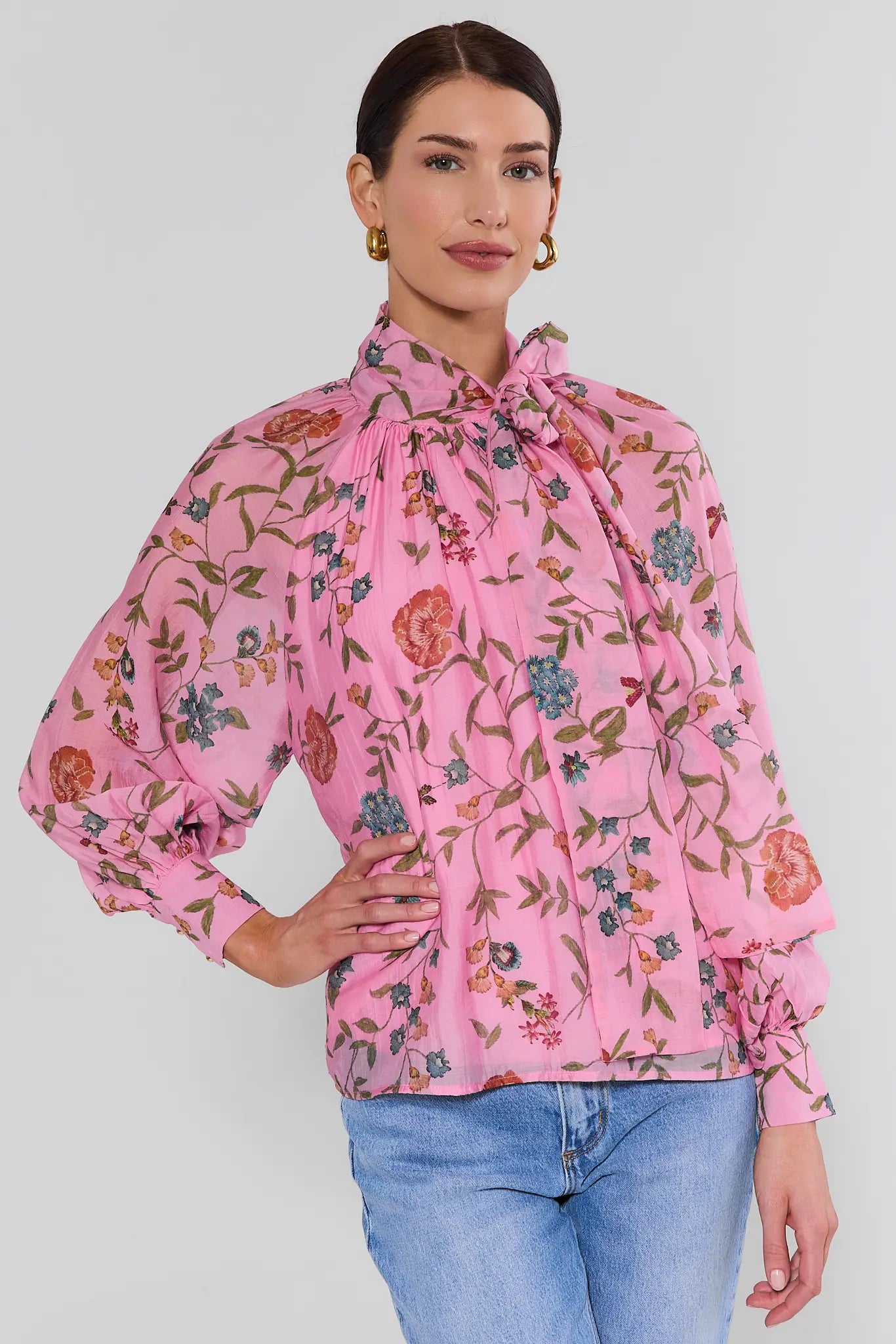 woman wearing long sleeve pink floral top and jeans