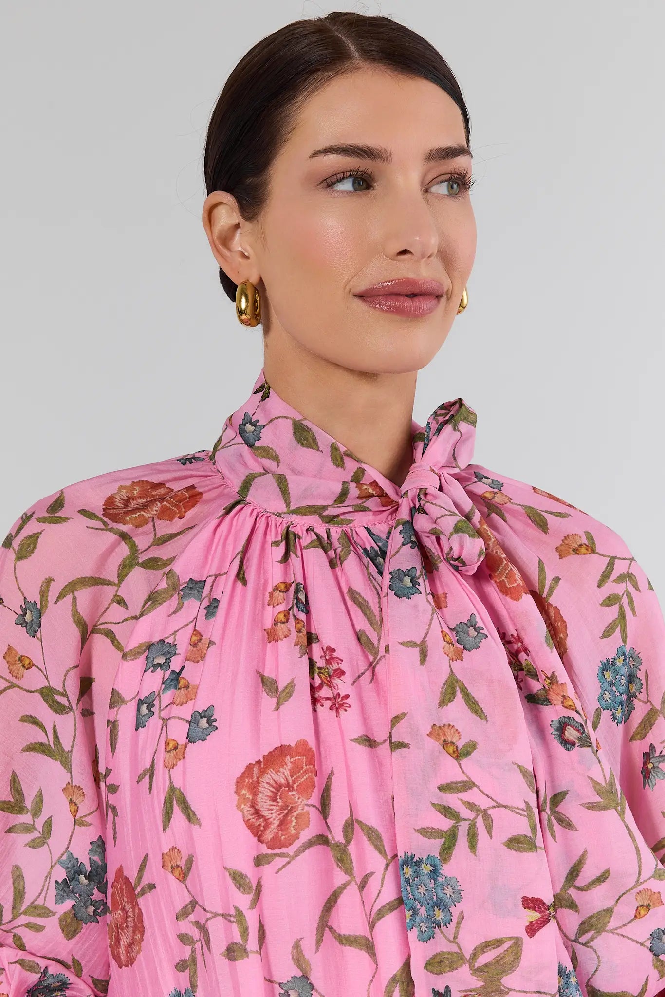 close up of woman wearing long sleeve pink floral top
