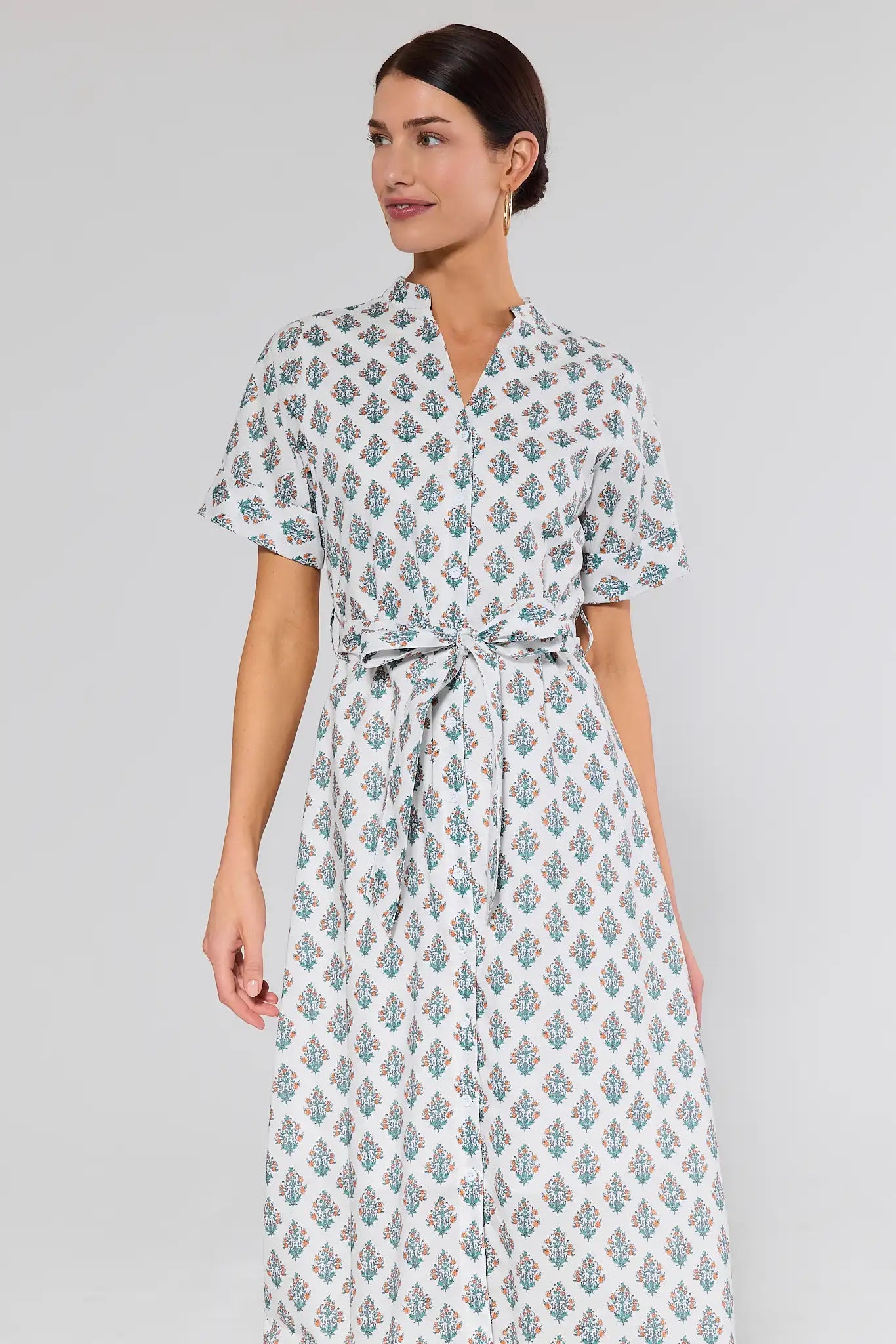 woman wearing white dress with floral block print on white background