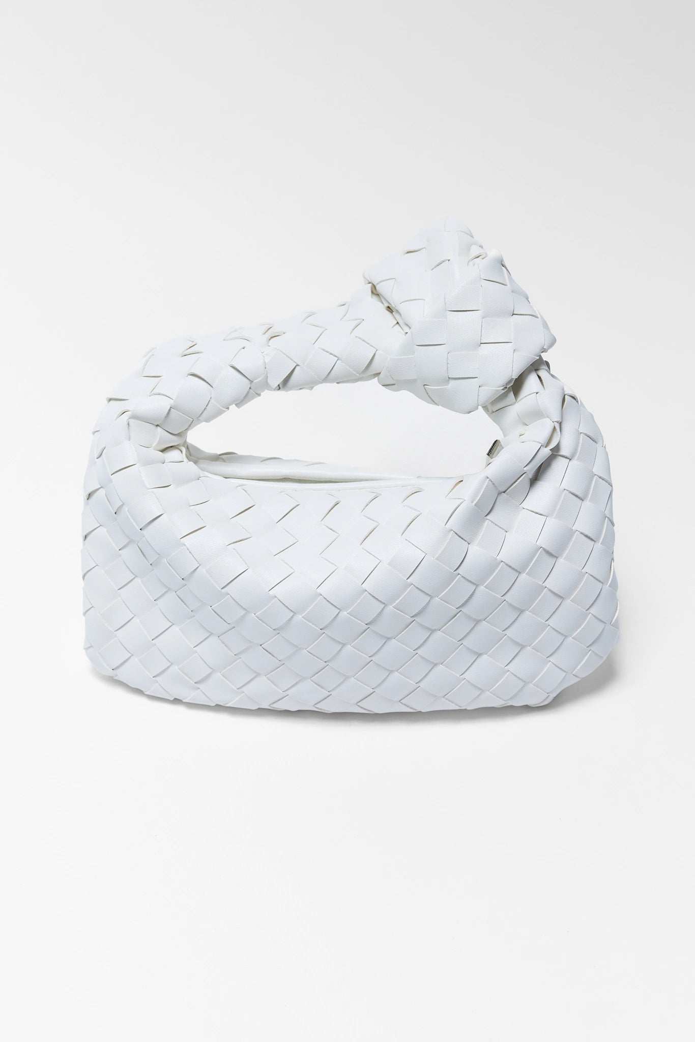 White woven handbag on a light gray background