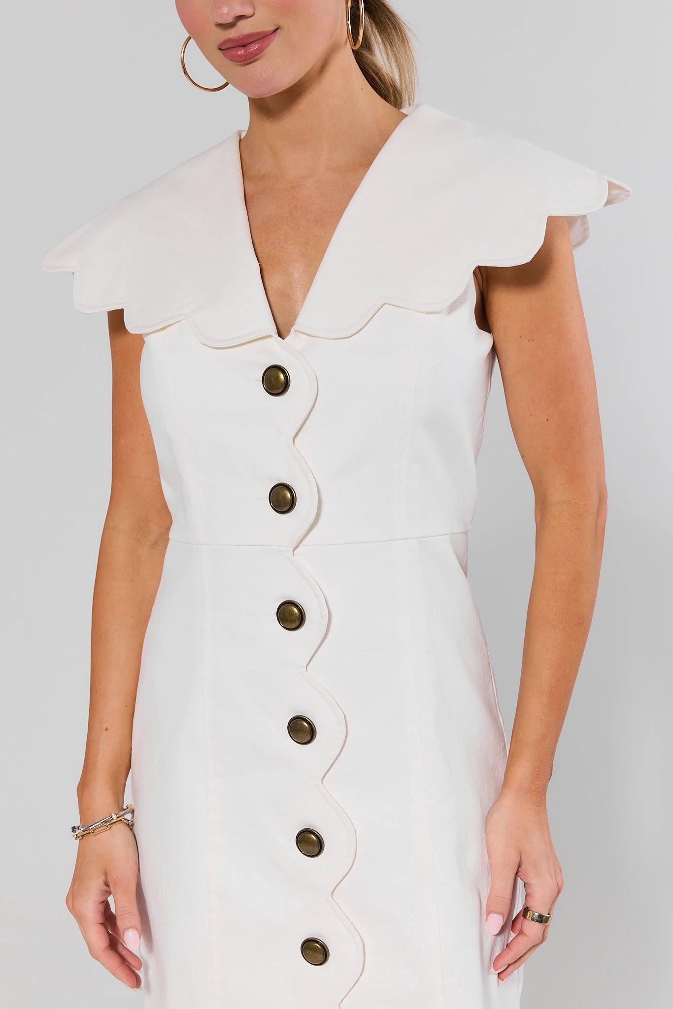 close up White dress with buttons and ruffled collar on a plain background