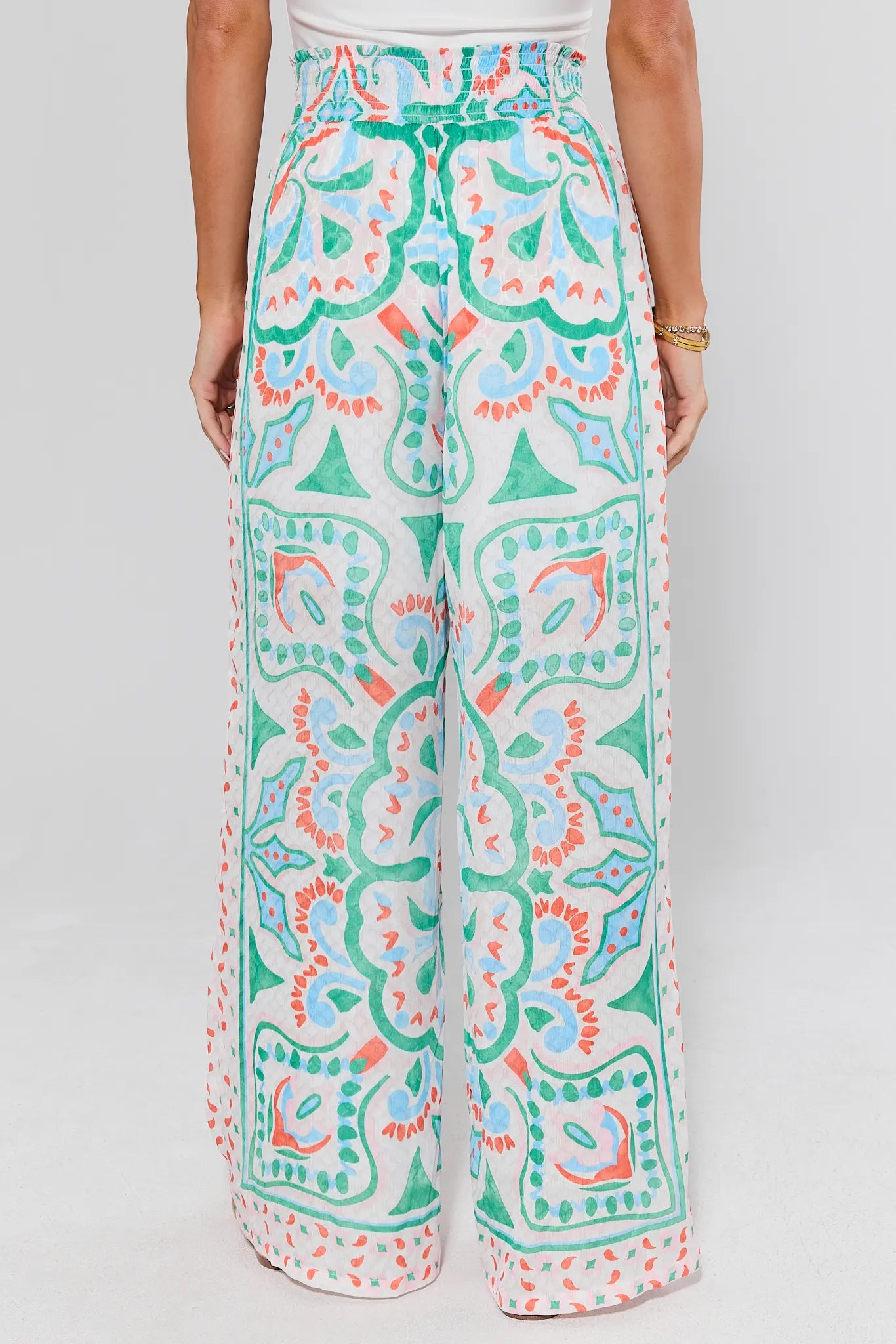 standing Colorful patterned pants worn by a person on a plain background