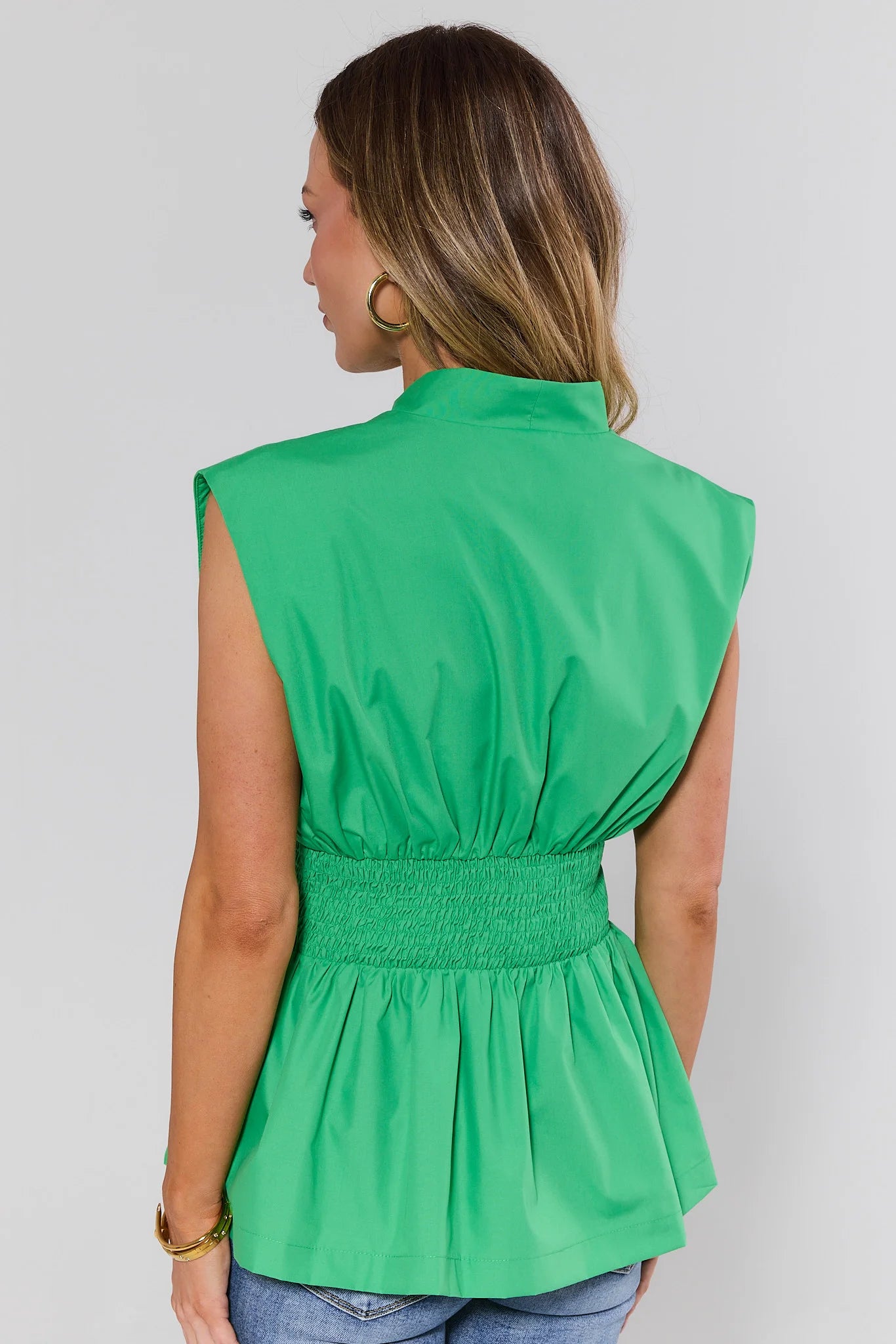 standing Green sleeveless top worn by a person on a plain background