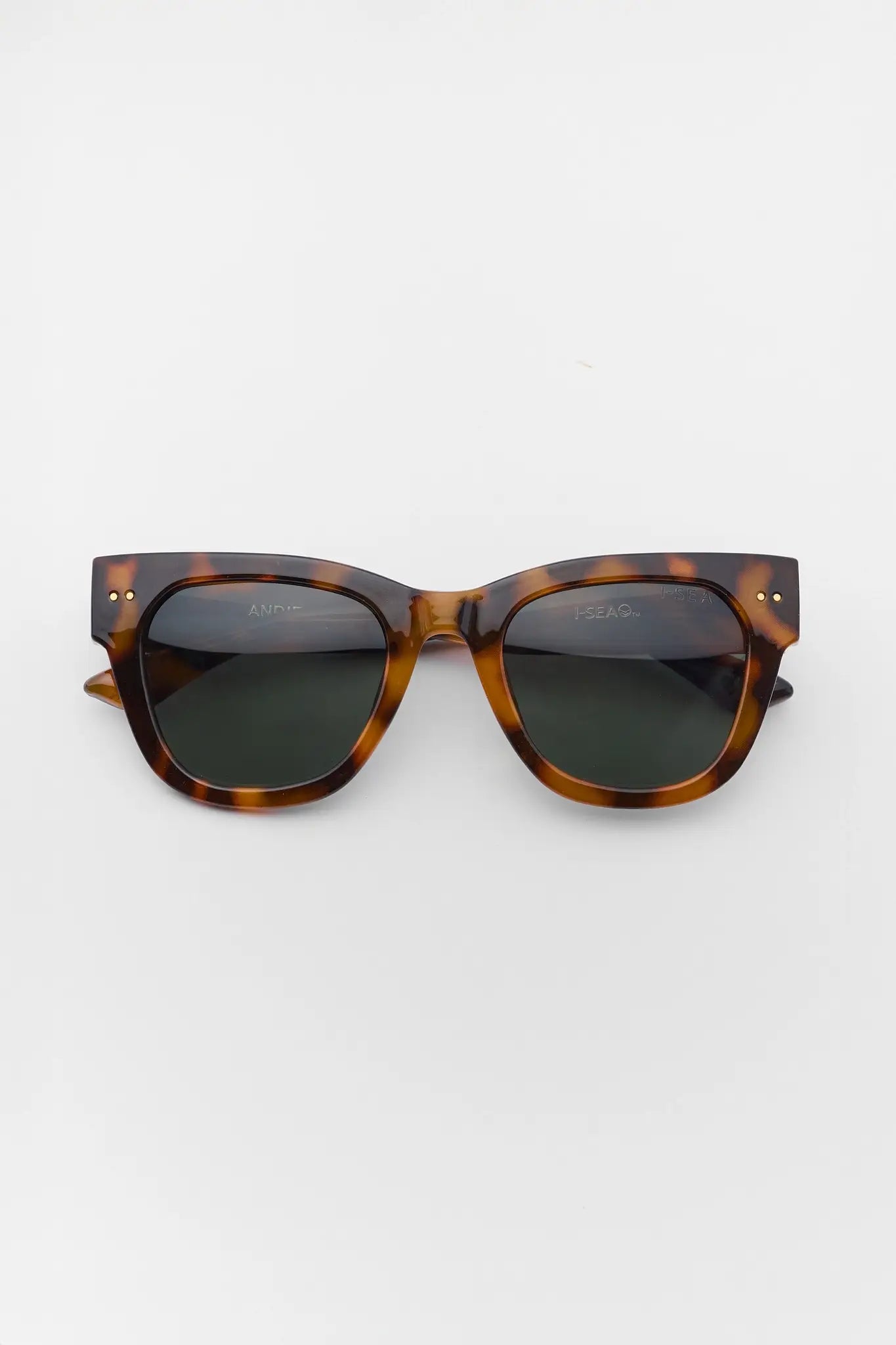 Sunglasses with tortoiseshell frame and dark lenses on a white background
